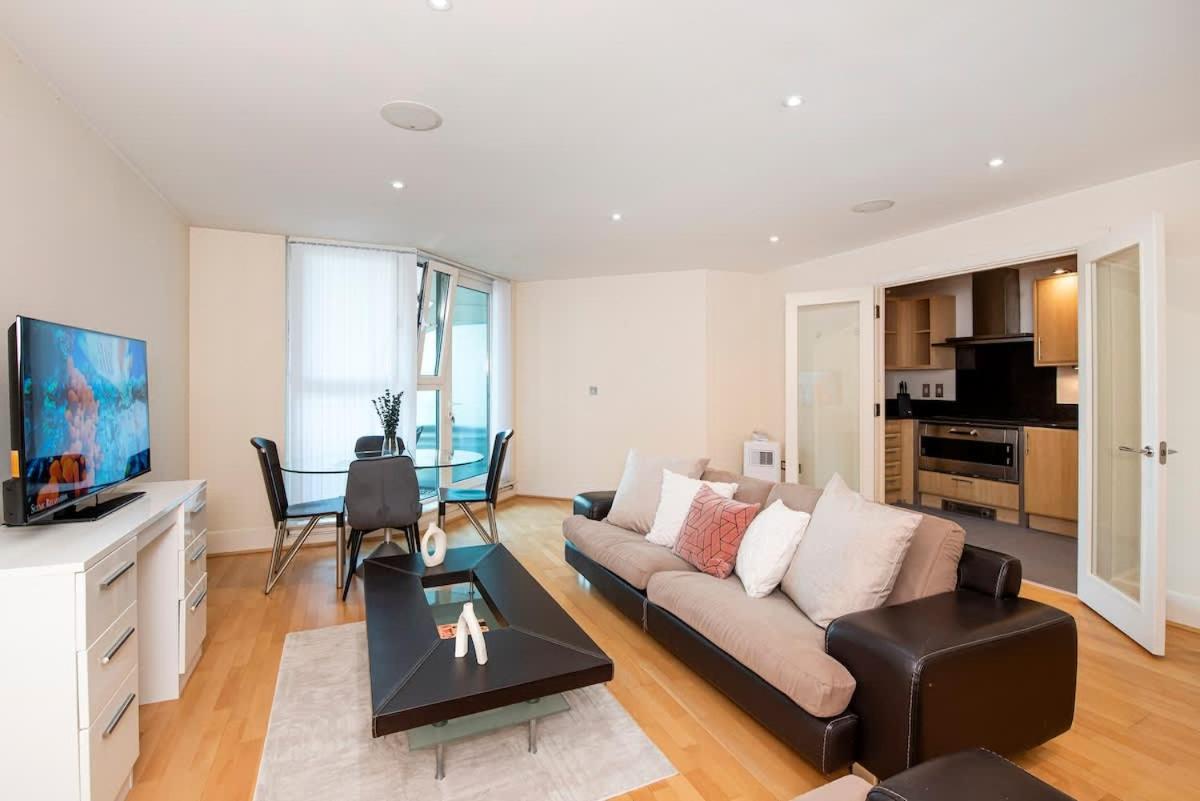 a living room with a couch and a table at Charming 2 bed Thames view in London