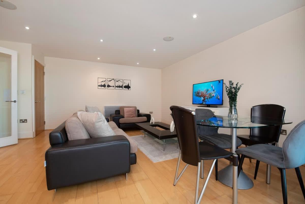 a living room with a table and a couch at Charming 2 bed Thames view in London