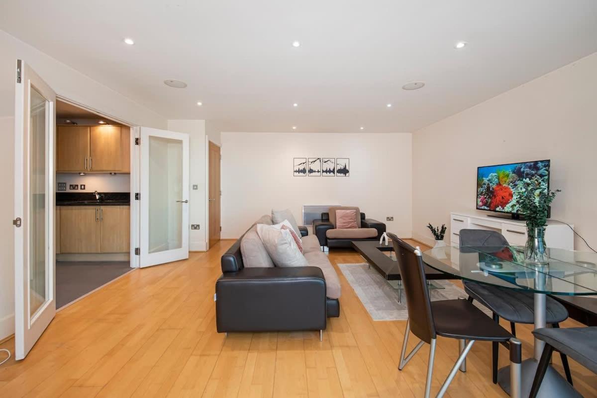 a living room with a couch and a glass table at Charming 2 bed Thames view in London +18 photos
