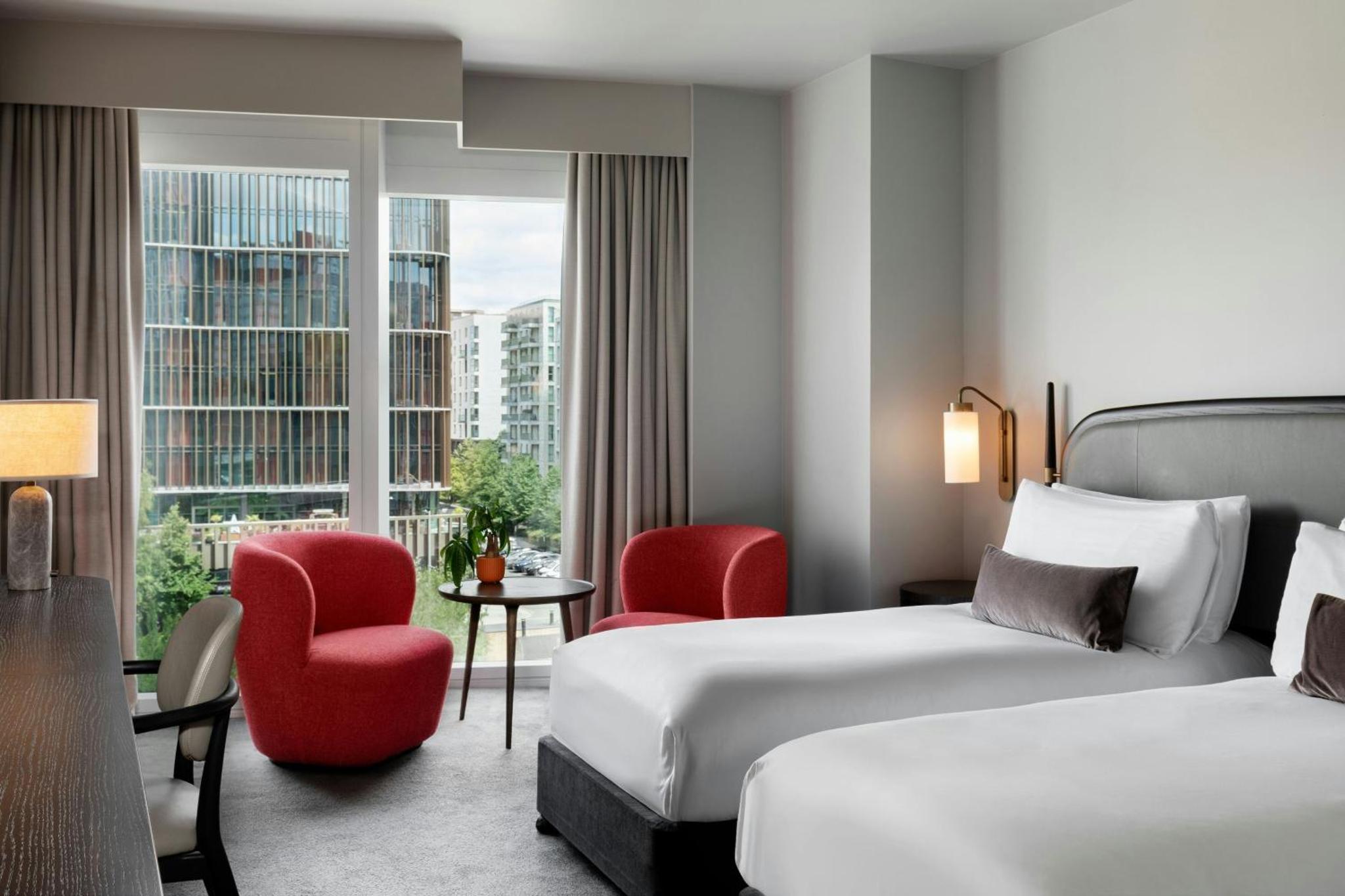 a hotel room with two beds and a window at The Stratford, Autograph Collection in London