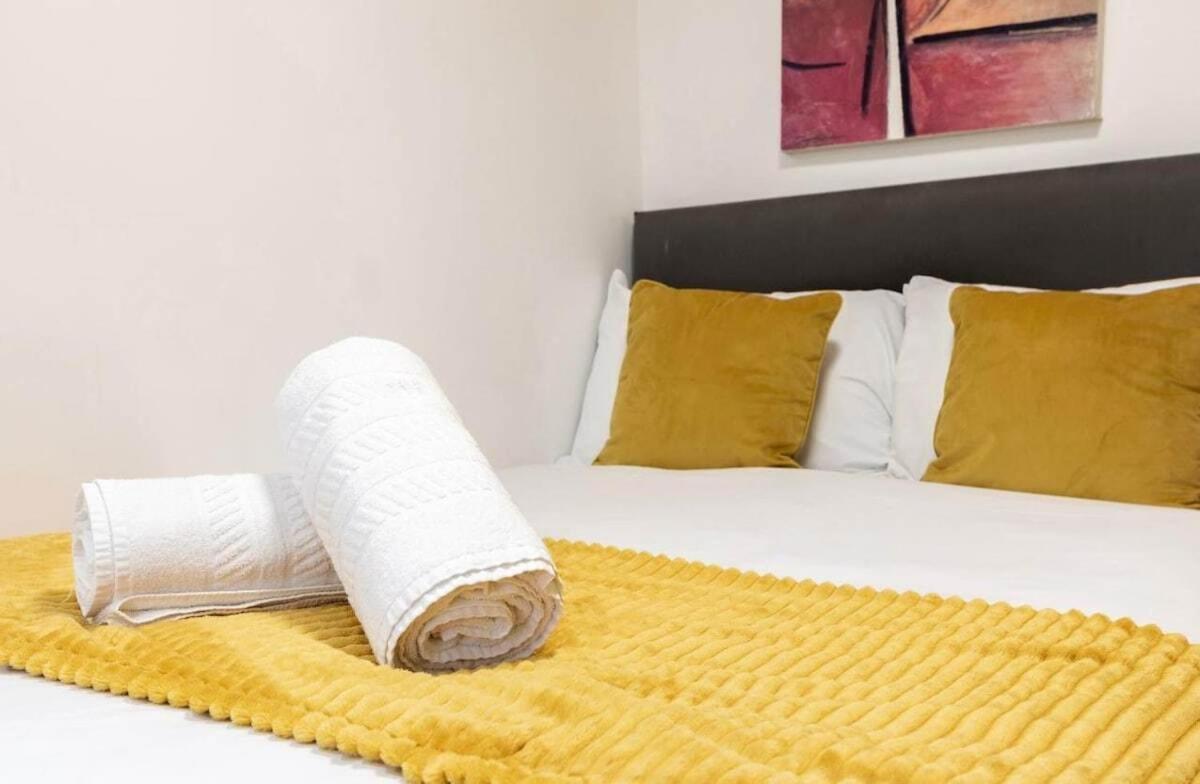 a roll of paper towels sitting on top of a bed at Hyde Park Budget Studios! in London +34 photos