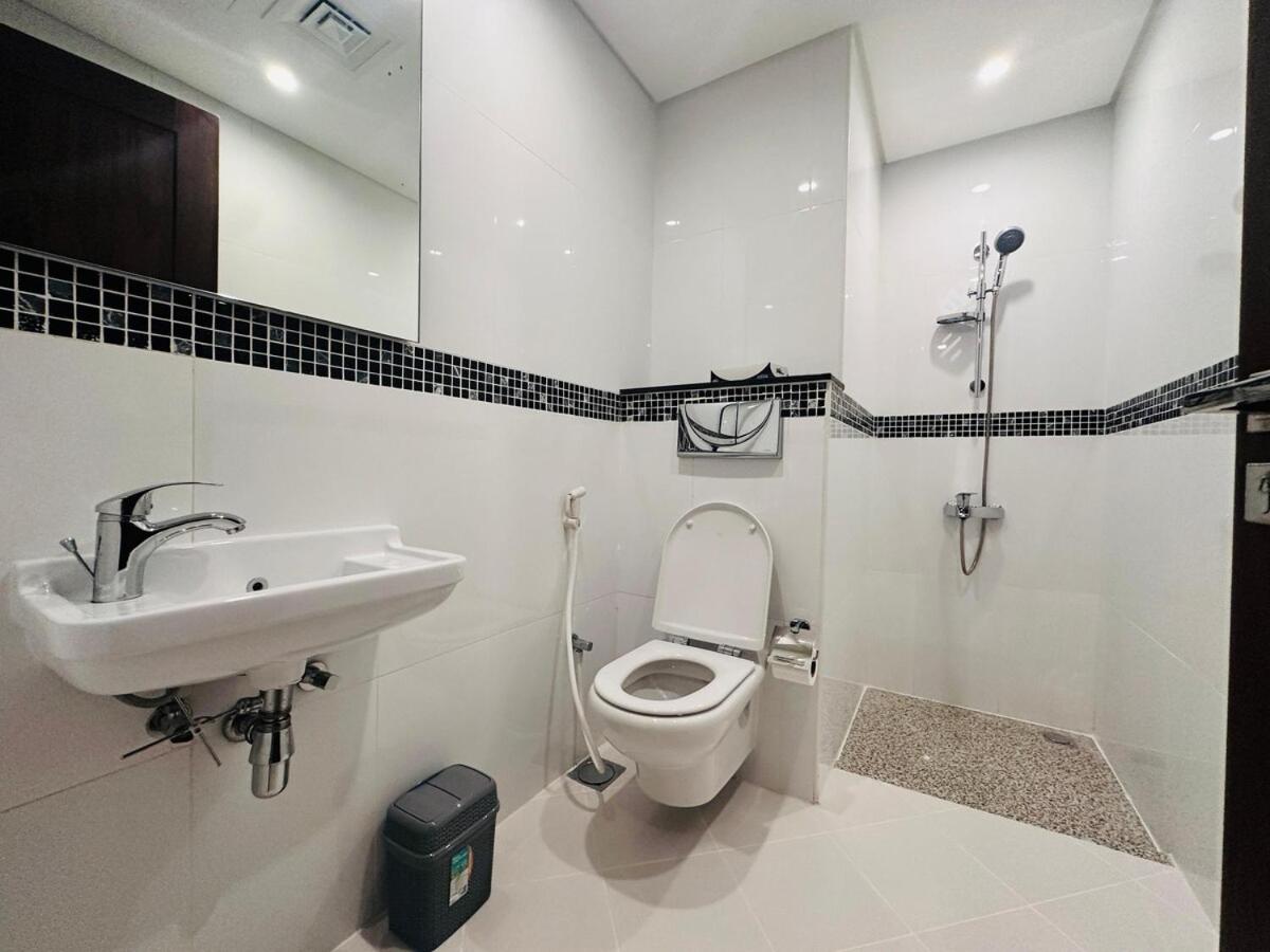 a bathroom with a toilet and a sink at Sea view 3 bd room apartment in Manama