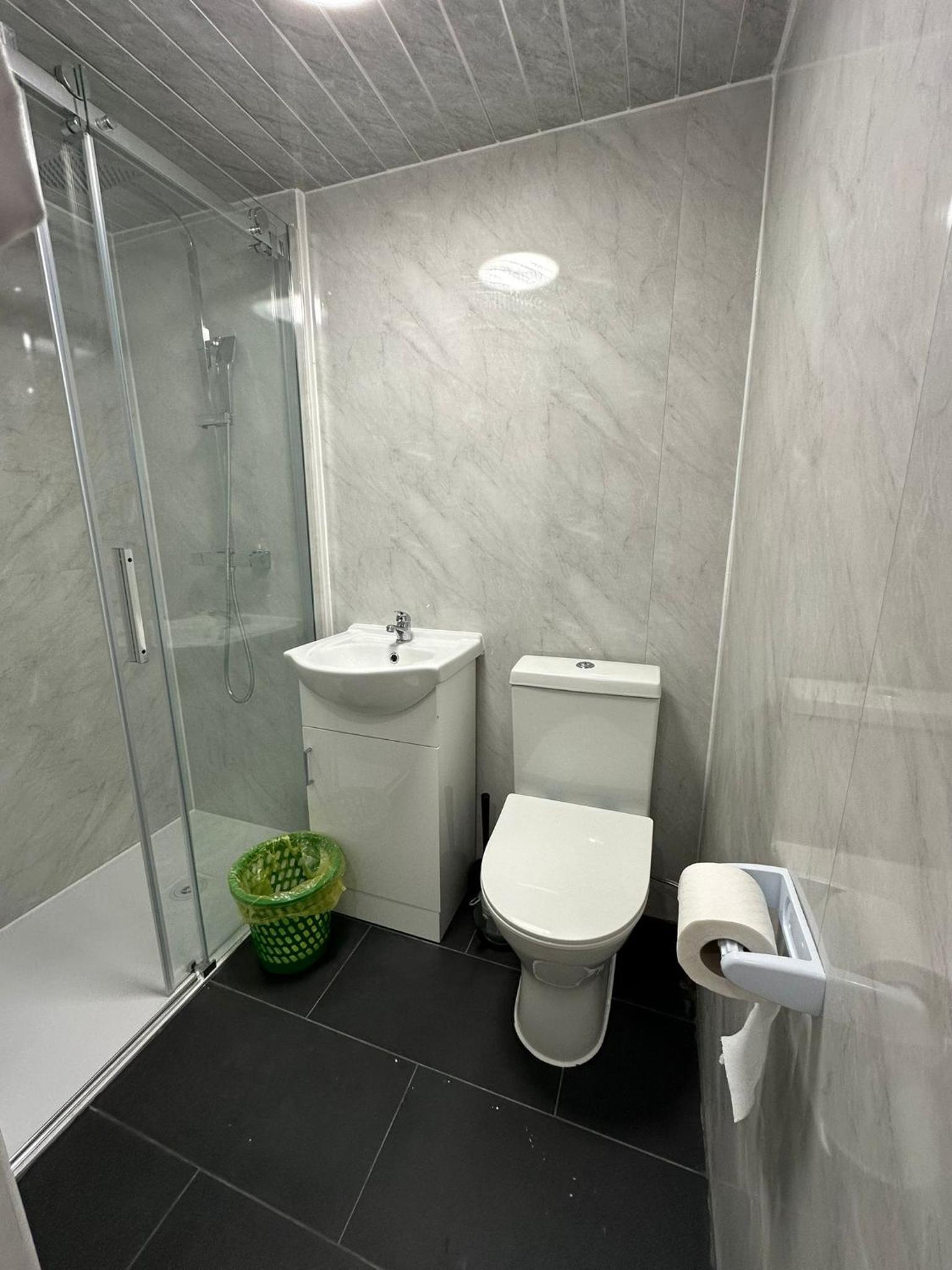 a bathroom with a toilet and a shower and a sink at Budget Ensuit Room, Quiet Stay, East London, Fast WiFi, Steps Away From London Eye, Near Metro in London