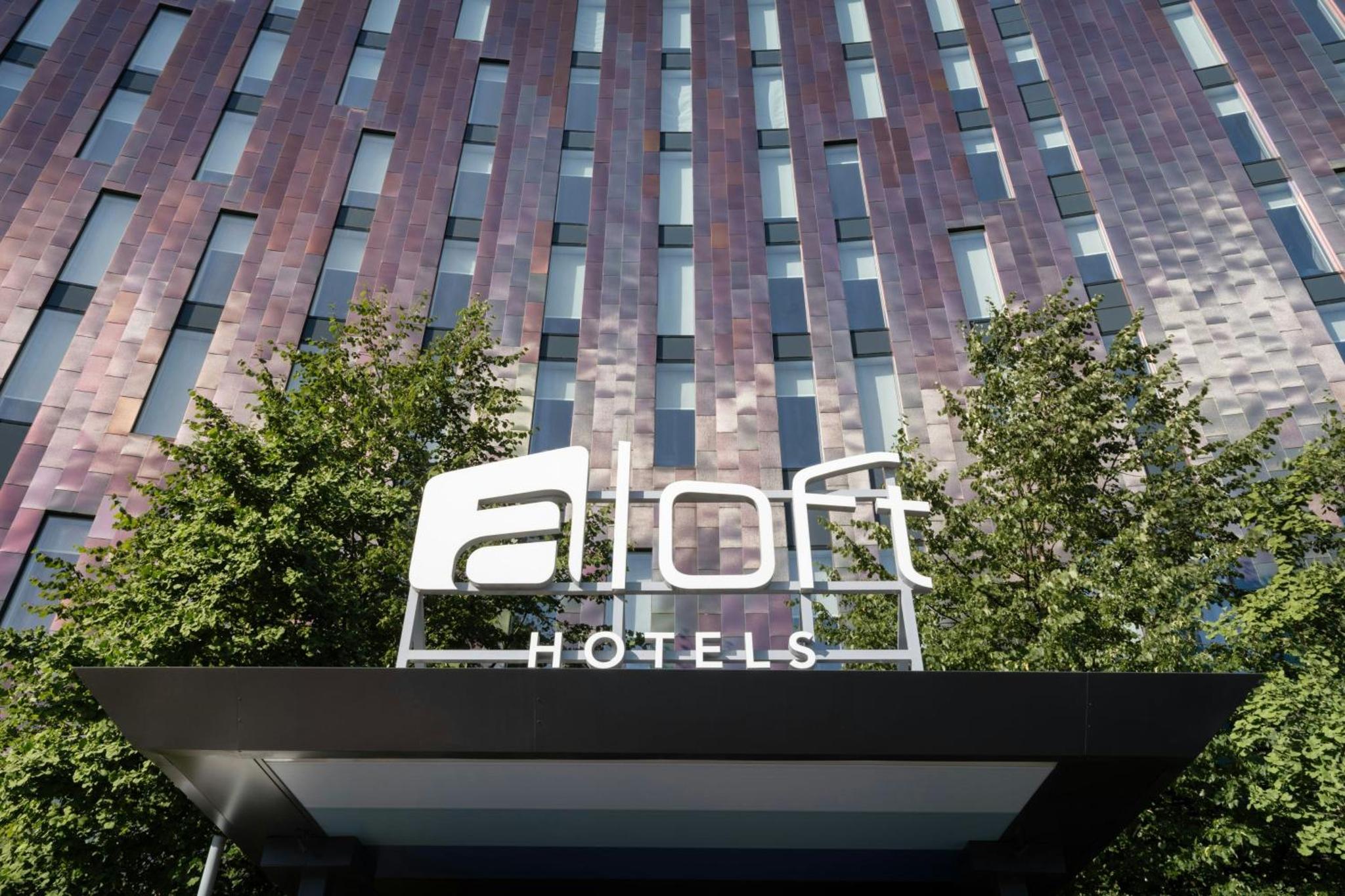 a sign for an aloft hotel in front of a building at Aloft London Excel in London