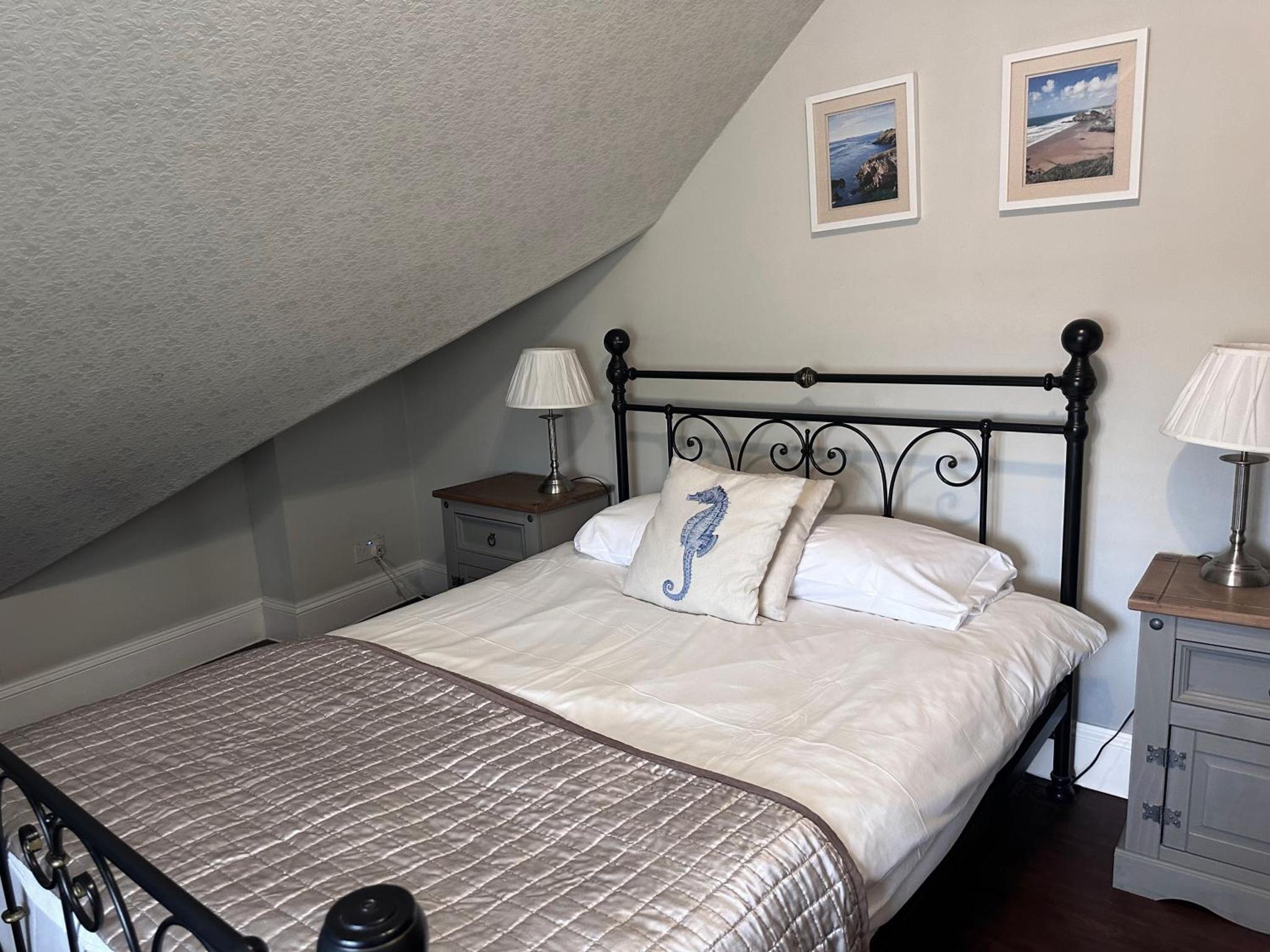 a bedroom with a bed and two night stands and two lamps at Balham Lodge in London +19 photos