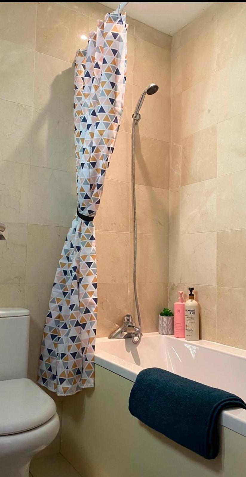 a bathroom with a shower with a toilet and a sink at Prime Location Wembley Stadium London in London