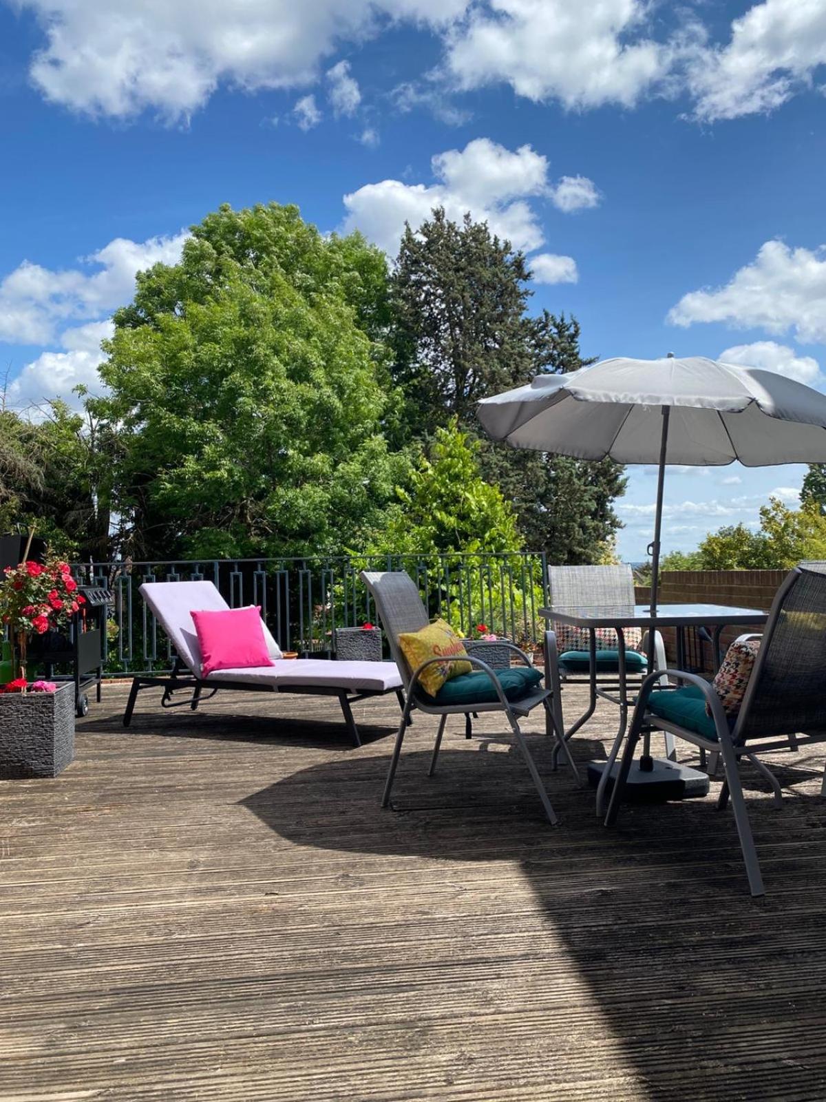 a group of chairs and an umbrella on a deck at Prime Location Wembley Stadium London in London