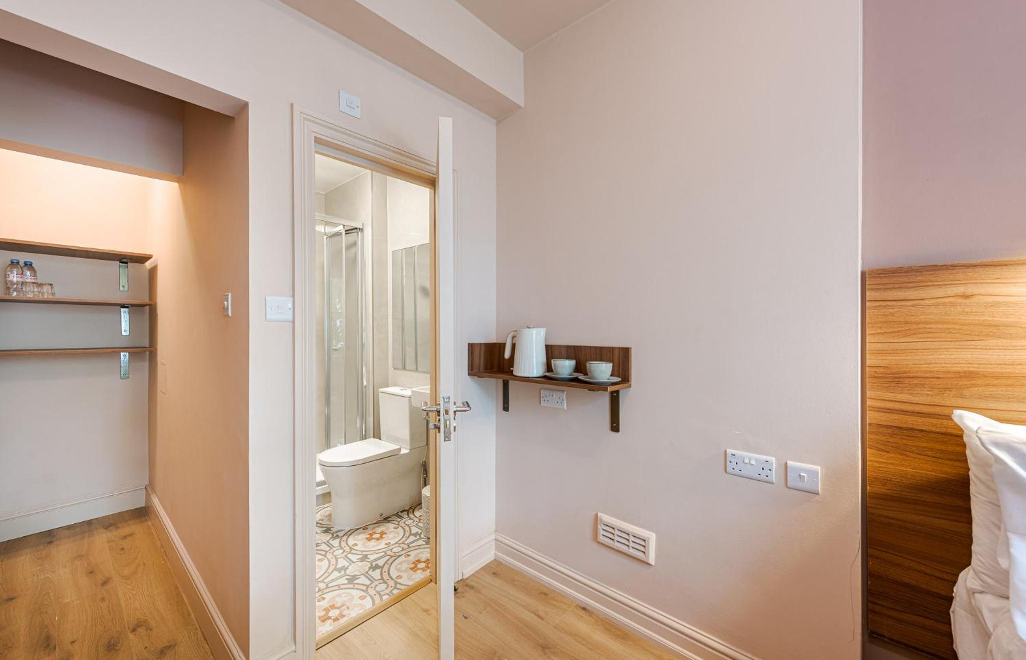 a bathroom with a toilet in a room at The Norfolk, Paddington in London