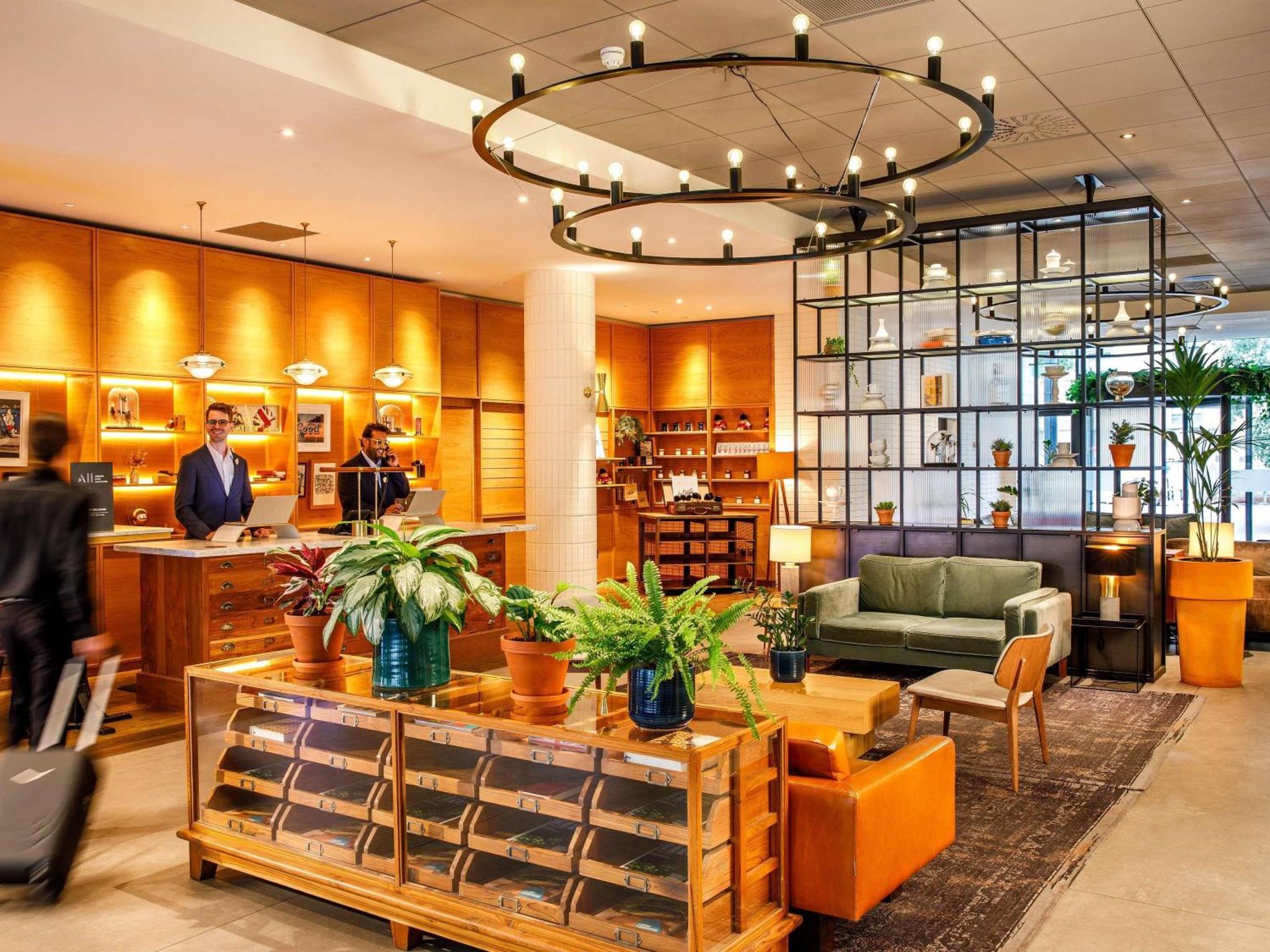 a lobby of a store with people in it at Novotel London Bridge in London