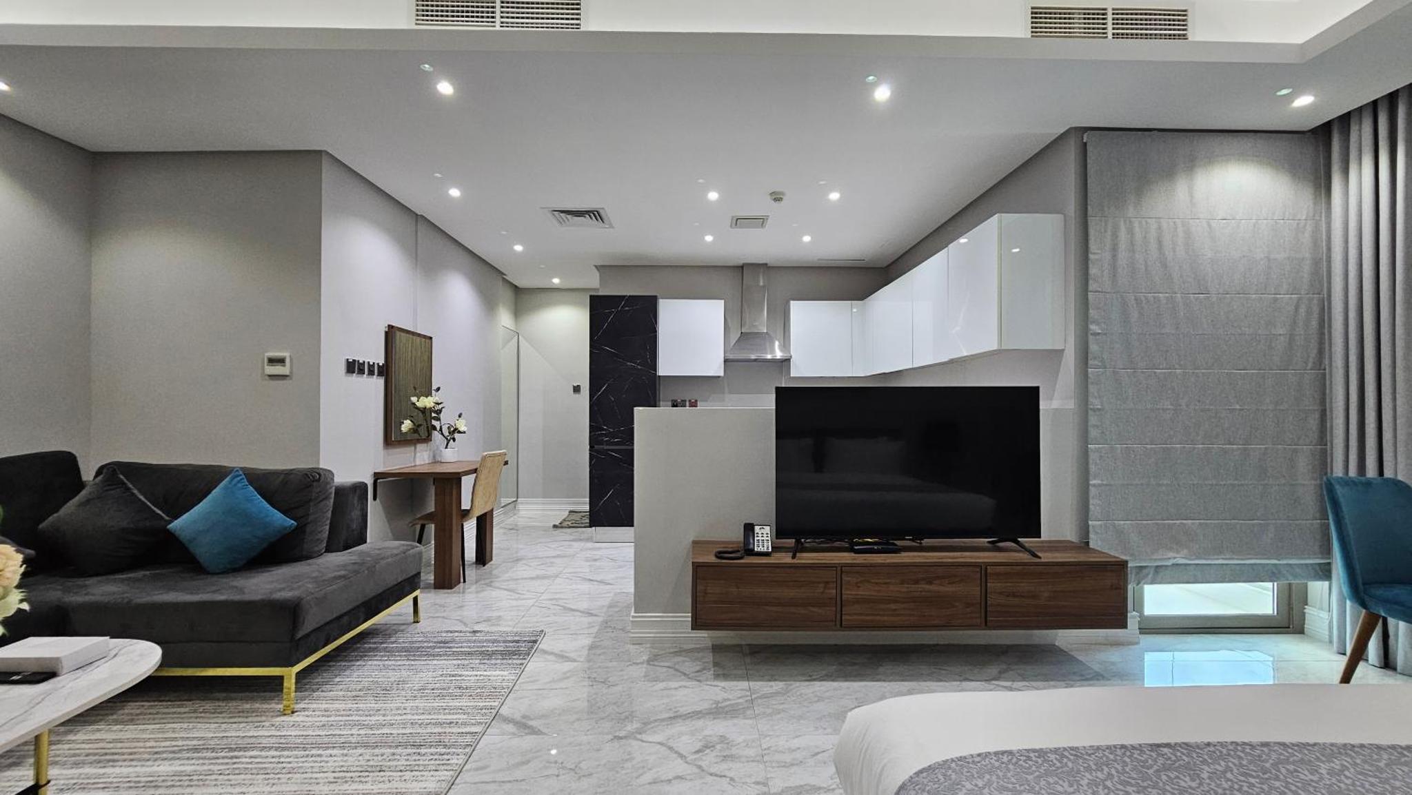 a living room with a television and a couch at Al Safwa 2 in Manama