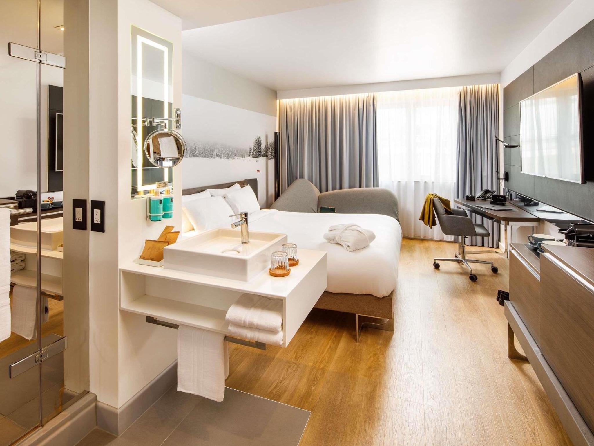 a hotel room with a bed and a sink at Novotel London Bridge in London