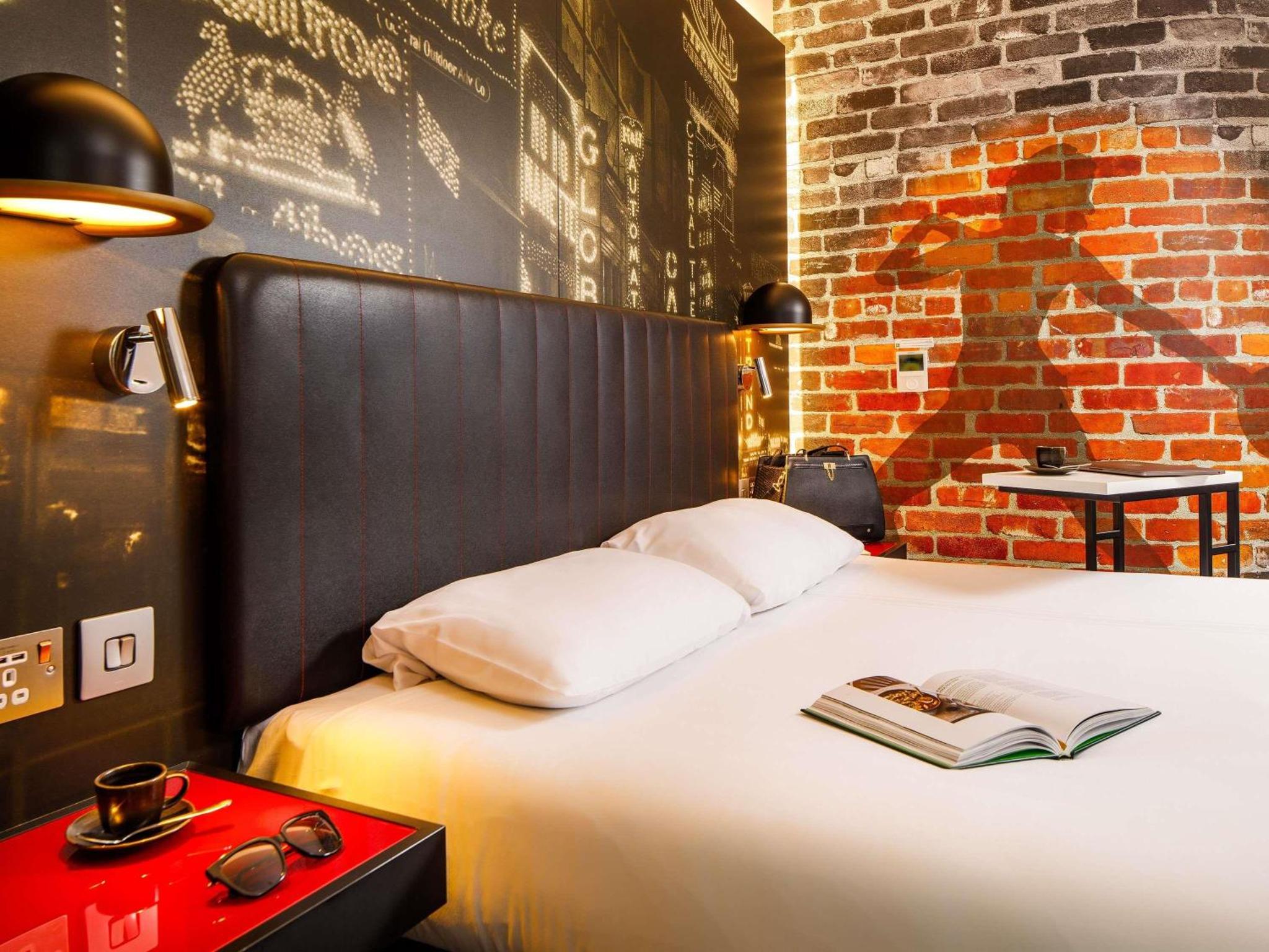 a bedroom with a bed with a book on it at ibis Styles London Southwark - near Borough Market in London