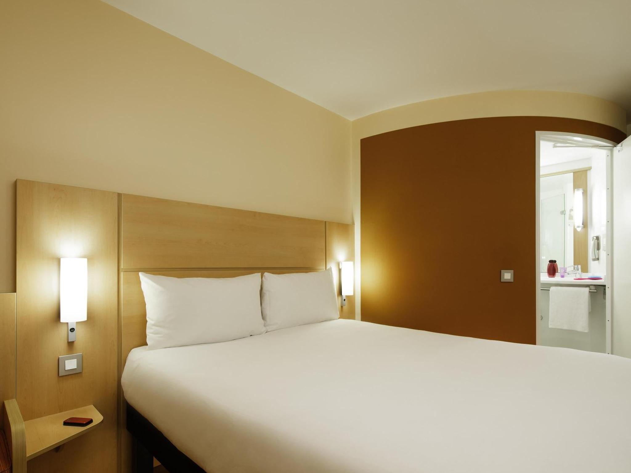 a bed in a hotel room with a large white bed at ibis London Shepherds Bush - Hammersmith in London