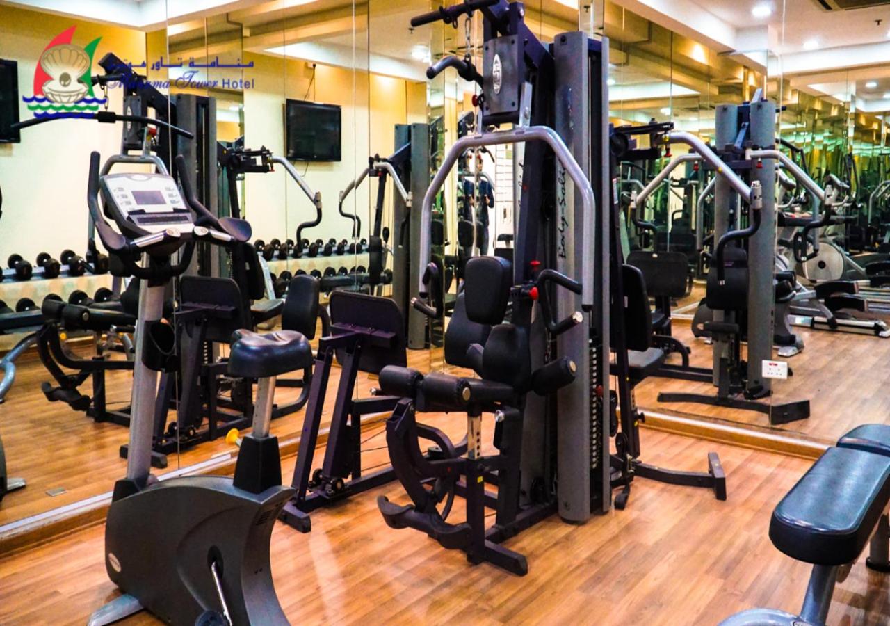 a gym with several rows of tread machines at Manama Tower Hotel in Manama