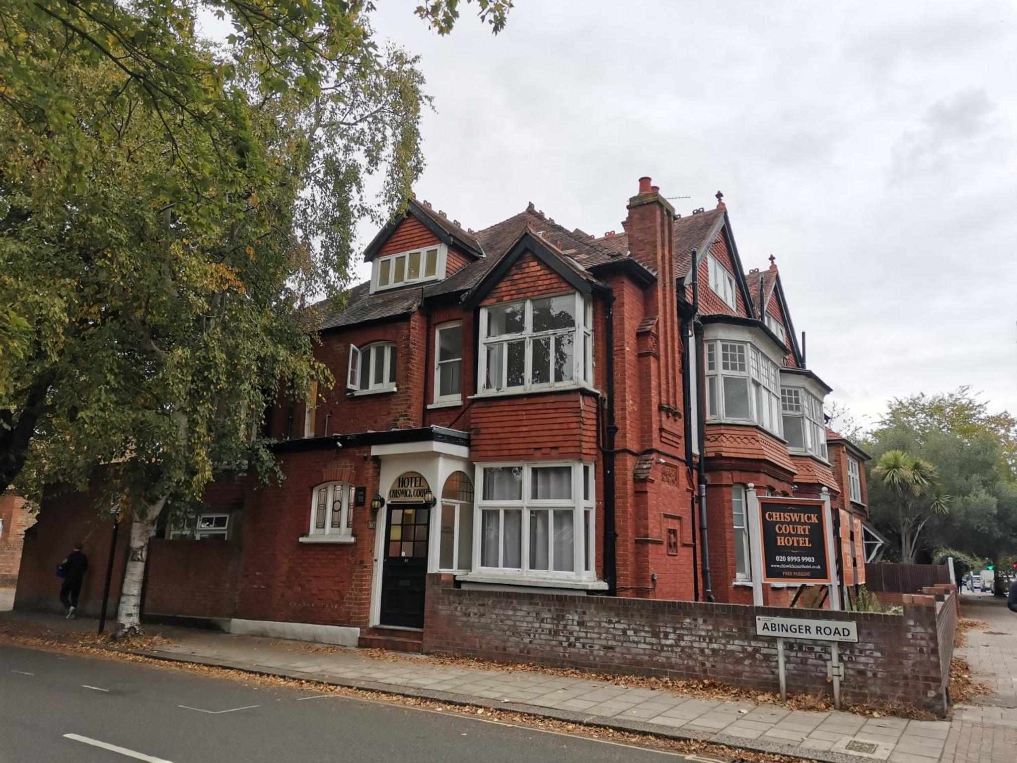 a red brick building on the side of a street at Chiswick Court Hotel in London