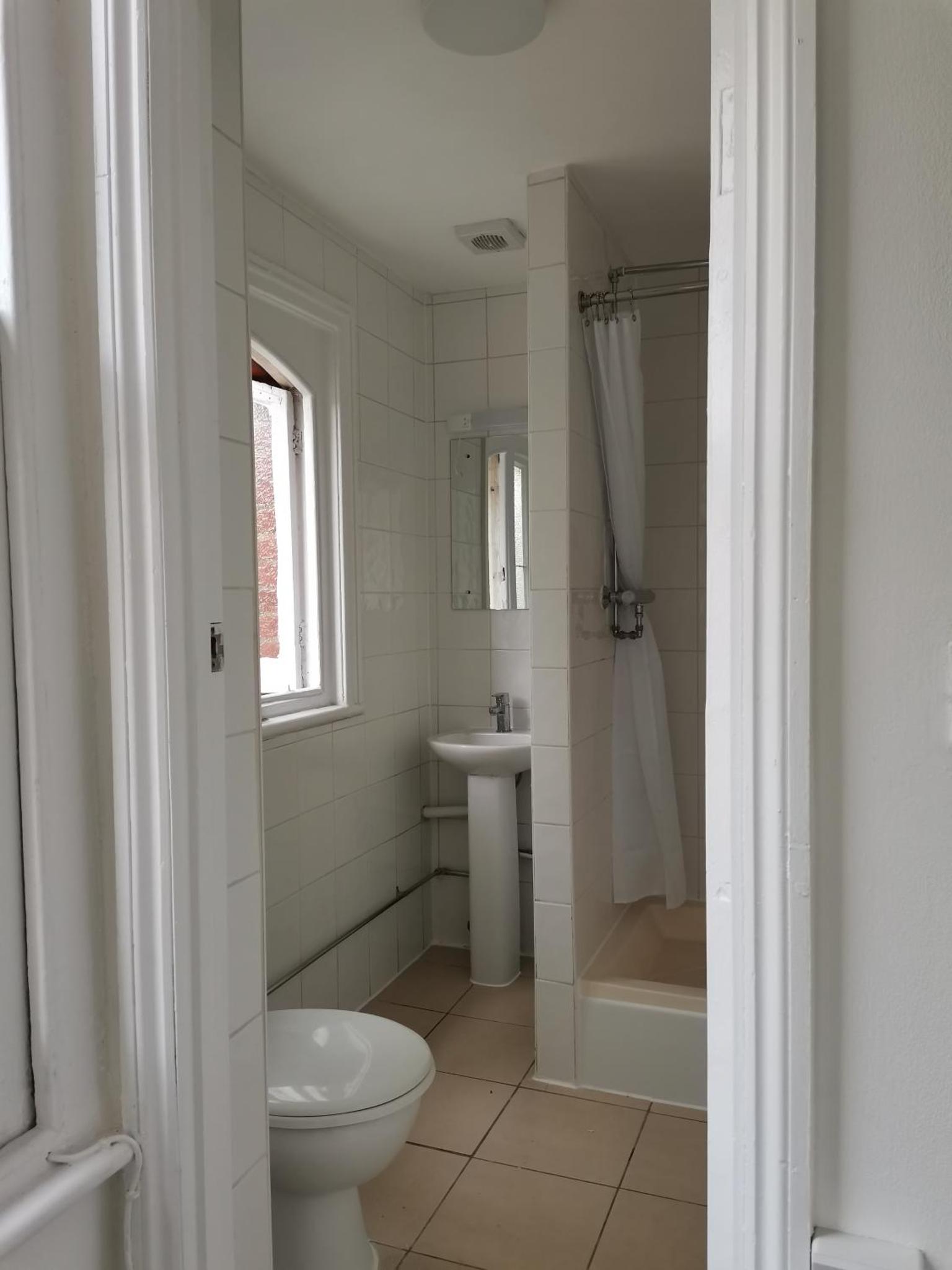 a white bathroom with a toilet and a sink at Chiswick Court Hotel in London +15 photos
