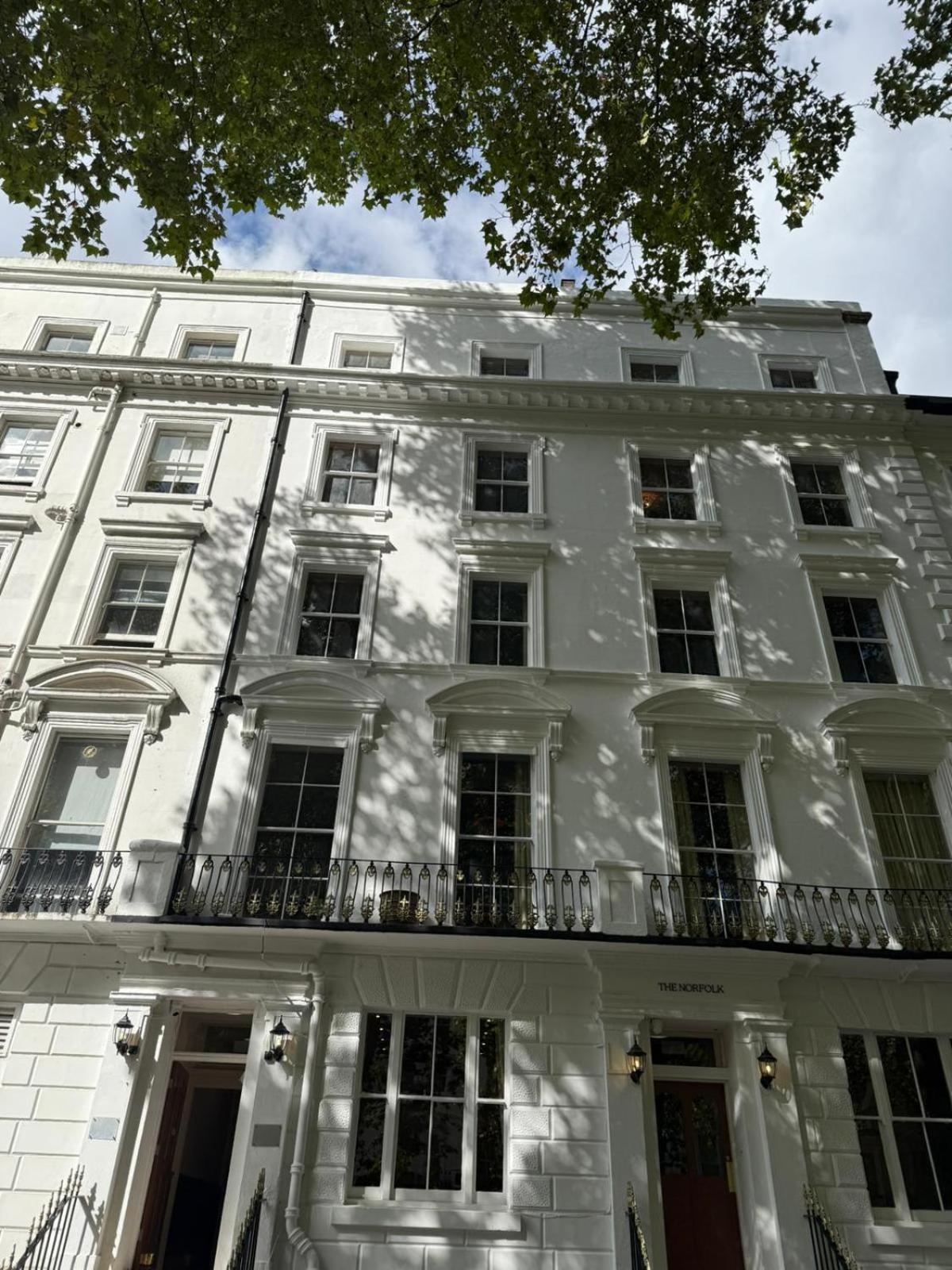 a large white building with a balcony at The Norfolk, Paddington in London