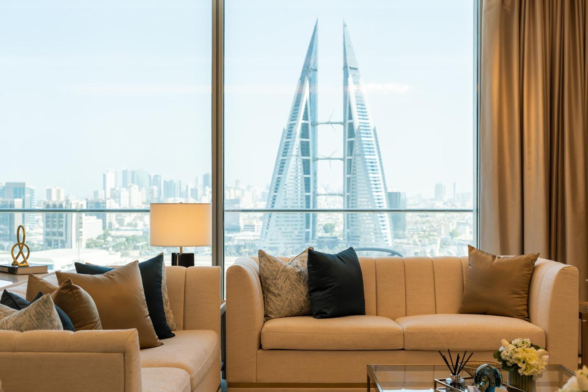 a living room with a couch and a large window at Onyx Rotana in Manama +77 photos
