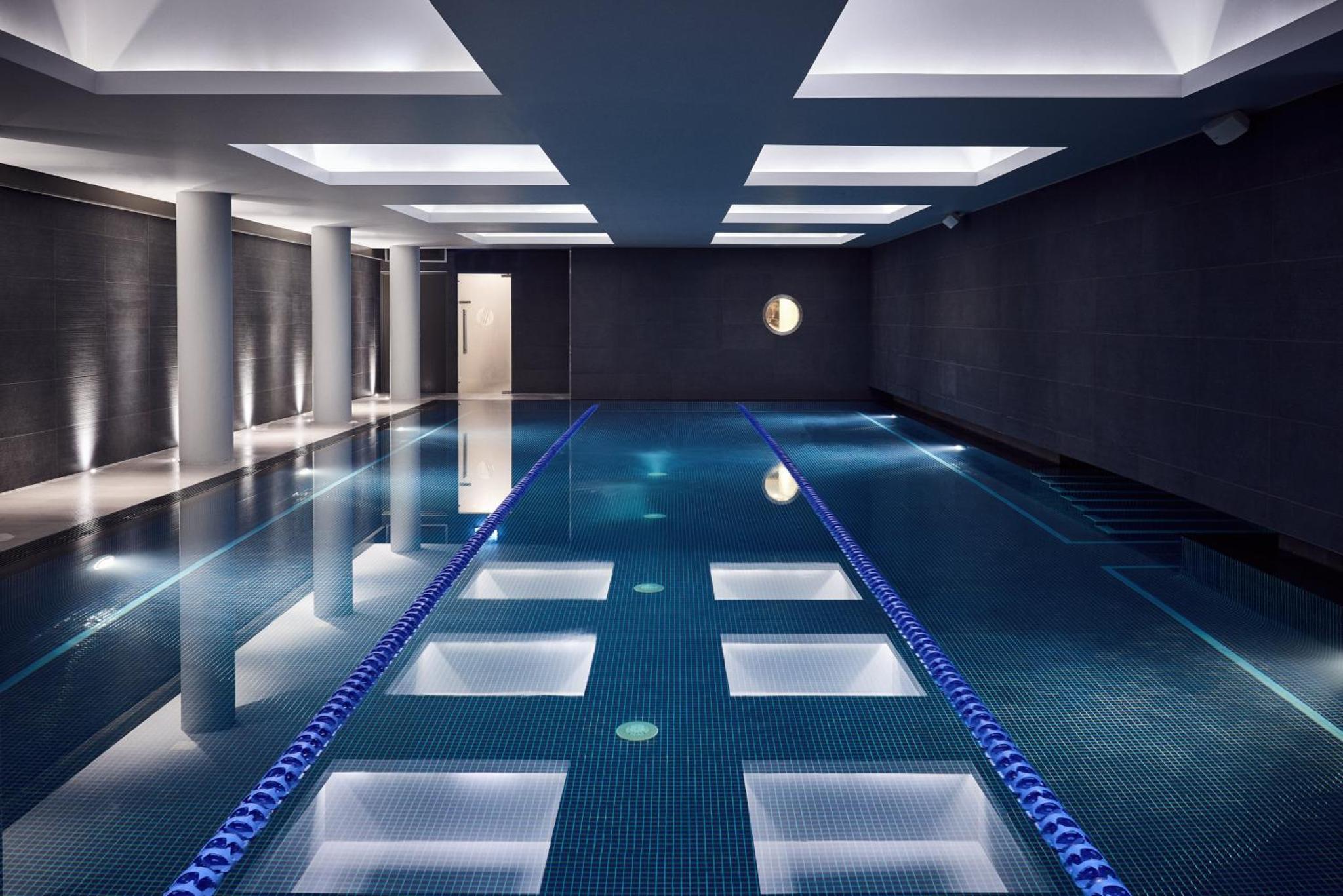 a pool in a building with a swimming pool at The Marylebone Hotel in London