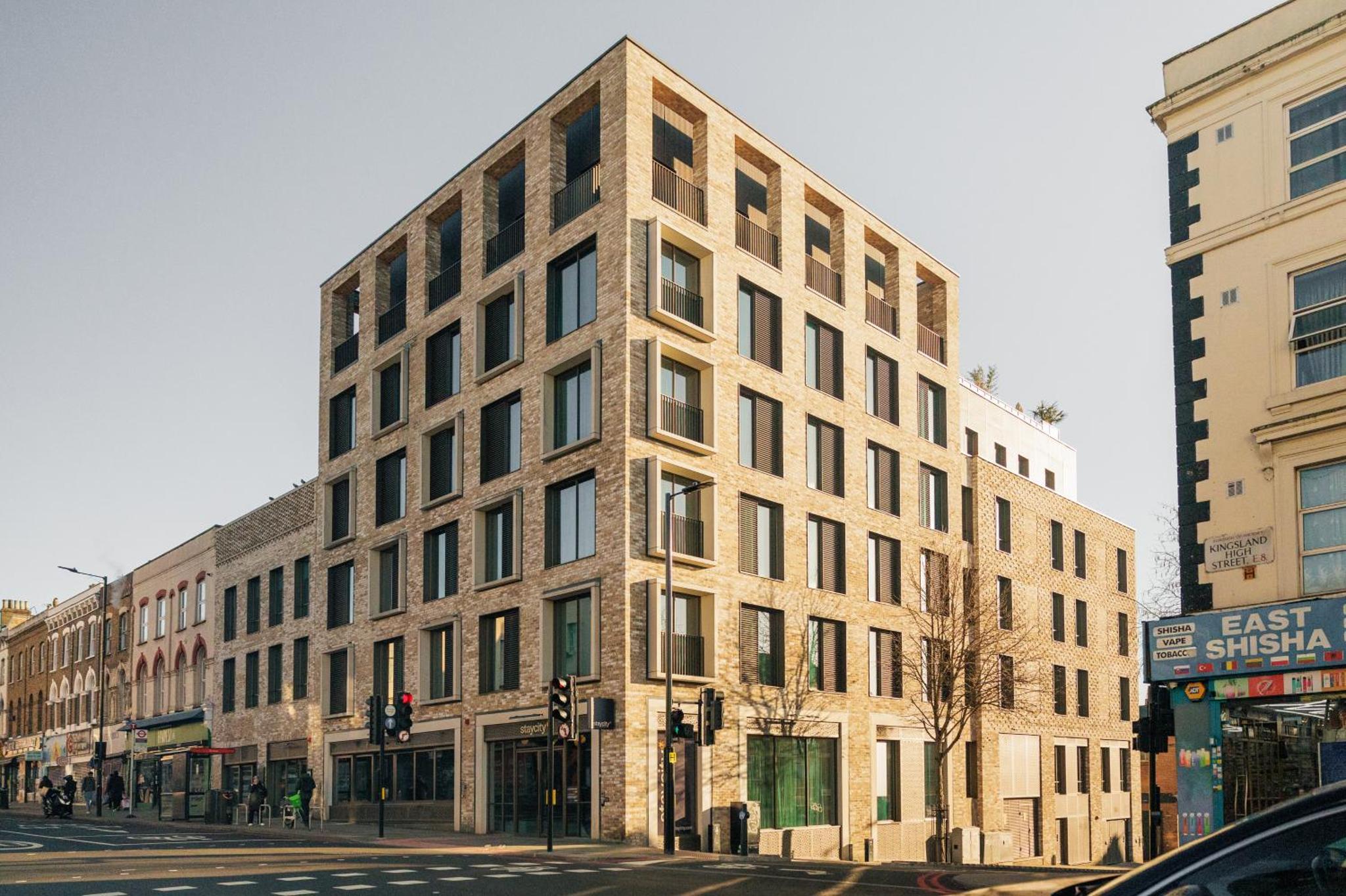 a large brick building on a city street at Staycity Aparthotels London Dalston in London