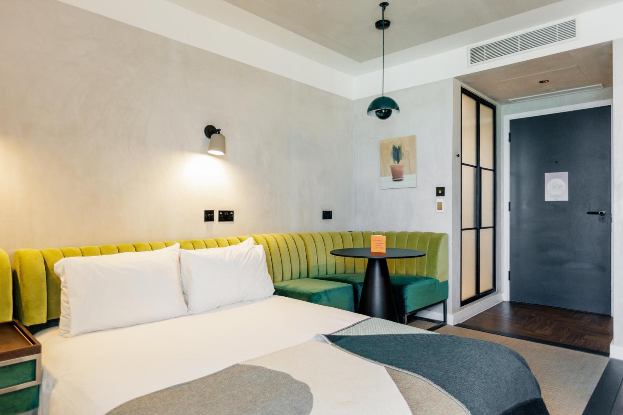 a room with a bed and a couch and a table at Staycity Aparthotels London Dalston in London