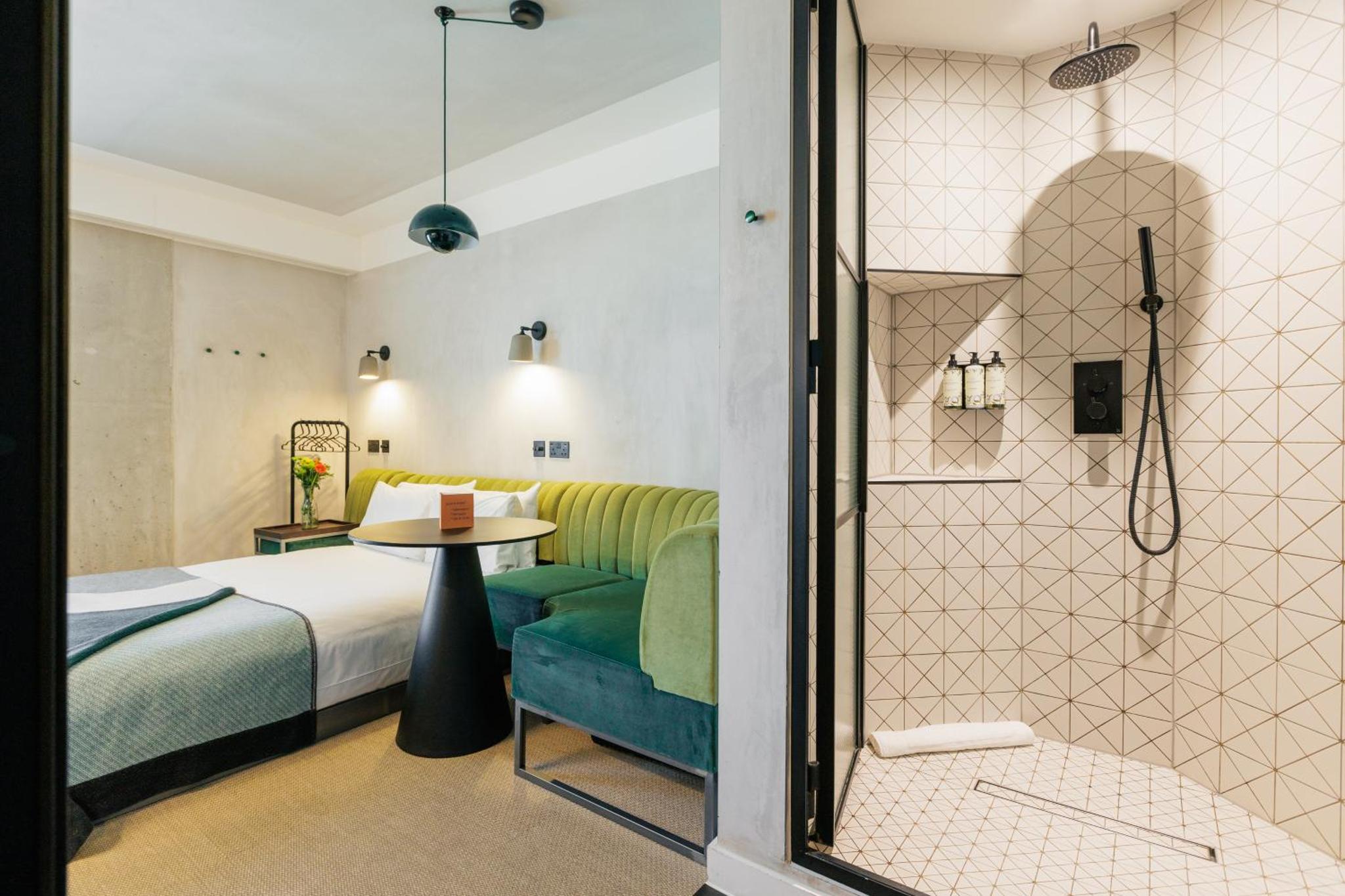a hotel room with a bed and a shower at Staycity Aparthotels London Dalston in London