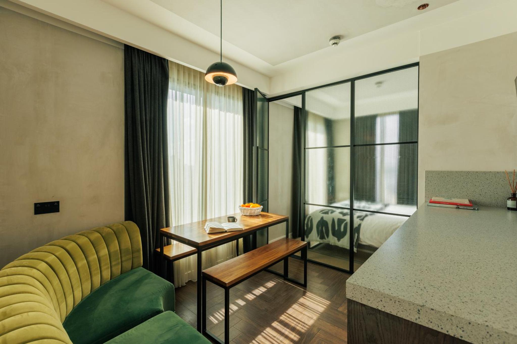 a hotel room with a couch and a table and a bed at Staycity Aparthotels London Dalston in London