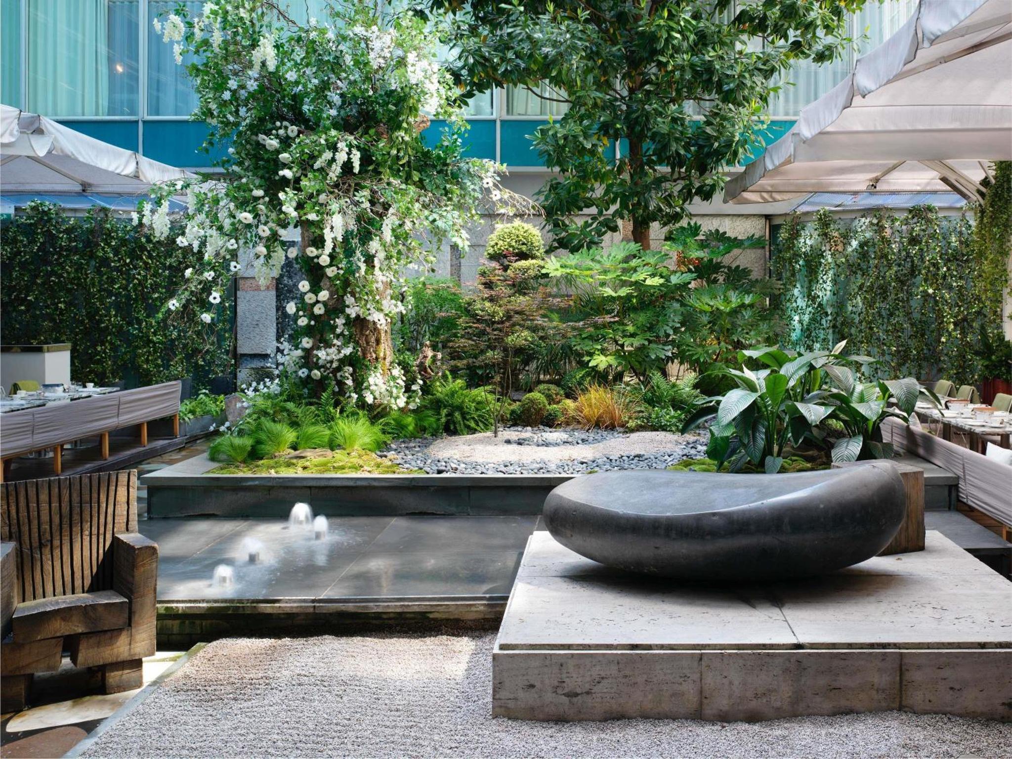 a garden with a large black sculpture in a building at Sanderson London in London