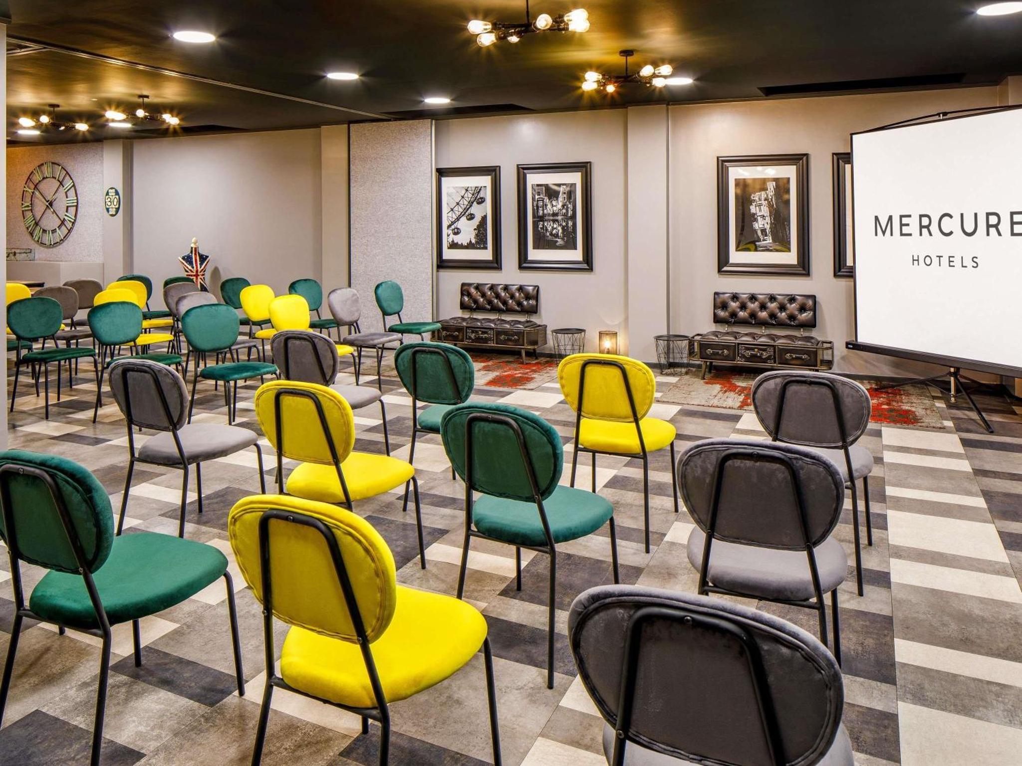 a room with chairs and a projection screen at Mercure London Bankside in London