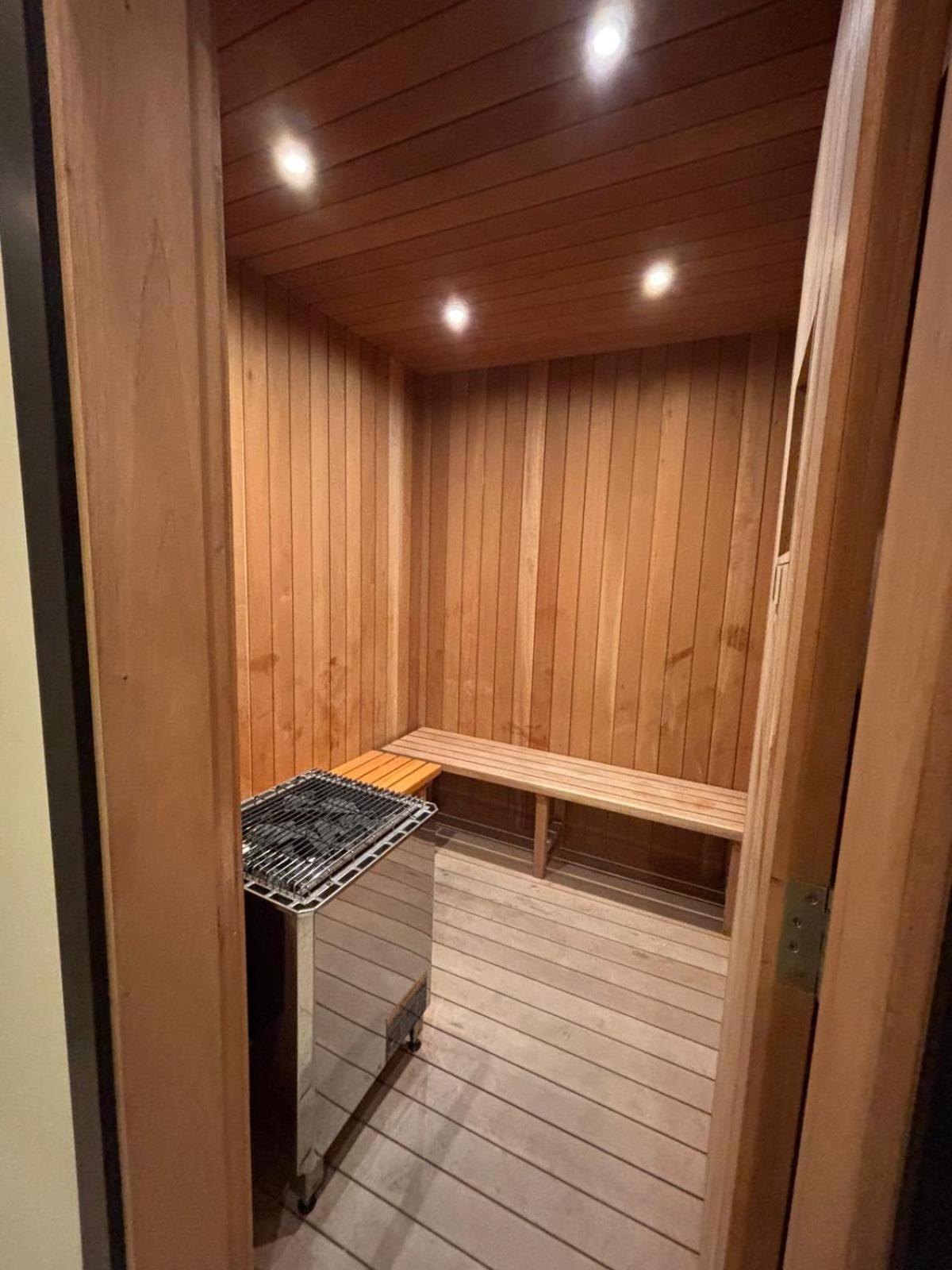 a room with a sauna with a wooden floor at Your dream place 1 BHK near City Centre Bahrain in Manama