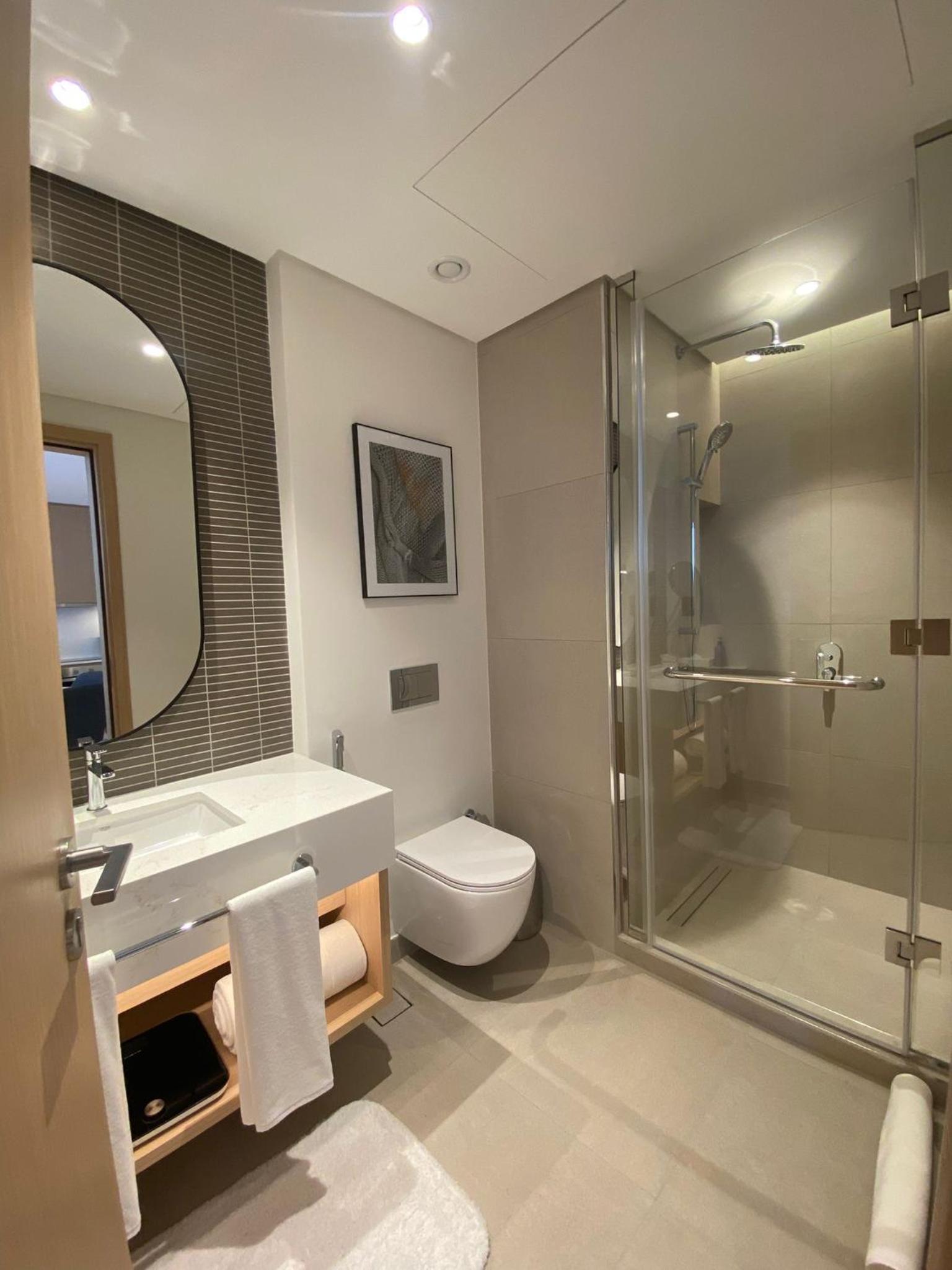 a bathroom with a sink and a toilet and a shower at Address Residence Marassi Vista-studio in Amwaj Island