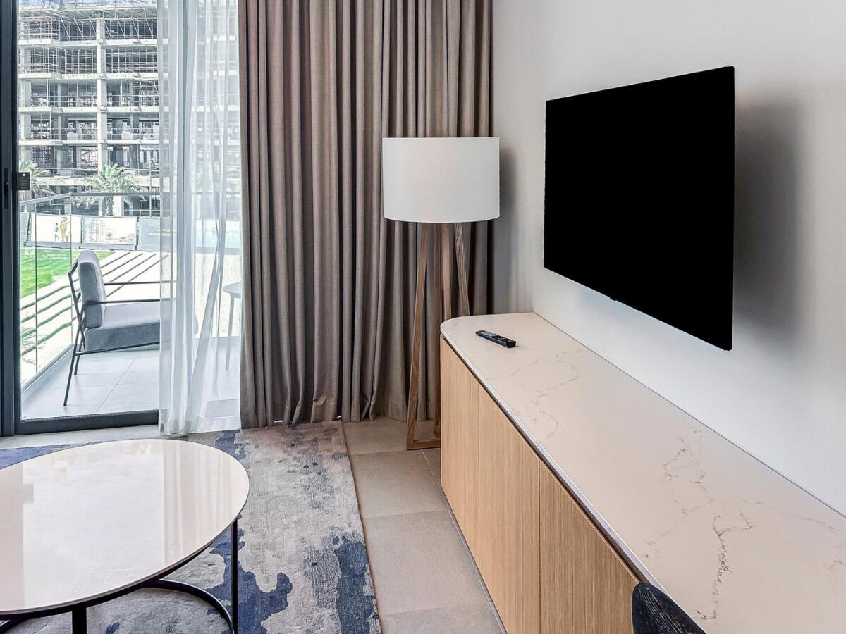 a room with a flat screen tv on a wall at Address Residence Marrasi Vista Apartment with Sea View in Amwaj Island