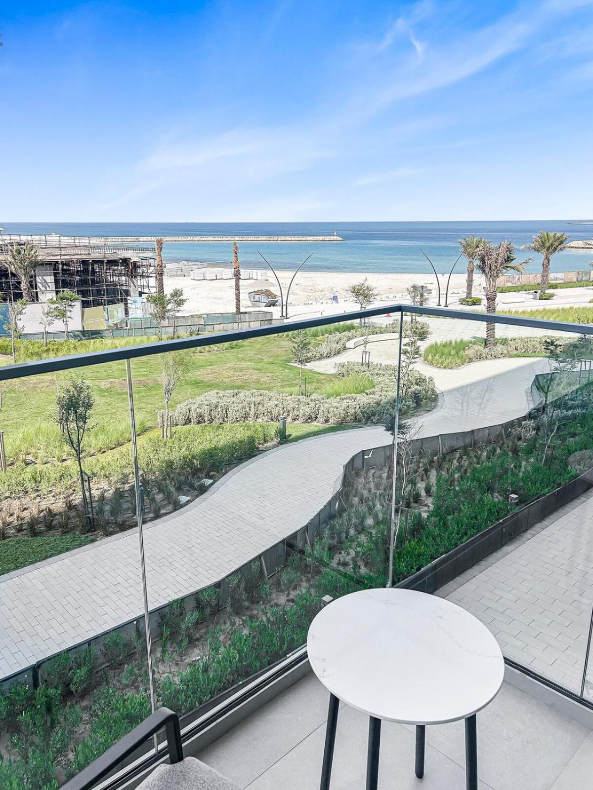 a balcony with a table and a view of the beach at Fancy Studio in Address Residence Marassi Vista in Amwaj Island