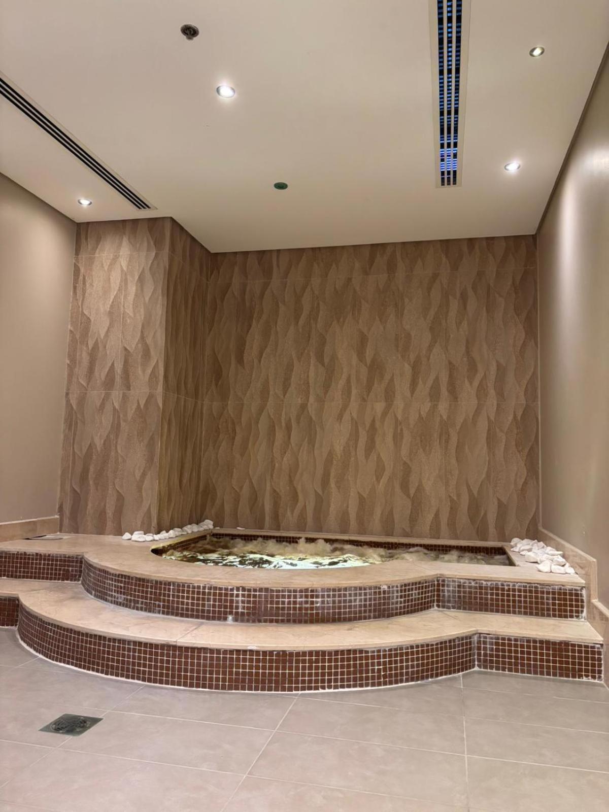a room with a wall with a large fountain at Your dream place 1 BHK near City Centre Bahrain in Manama