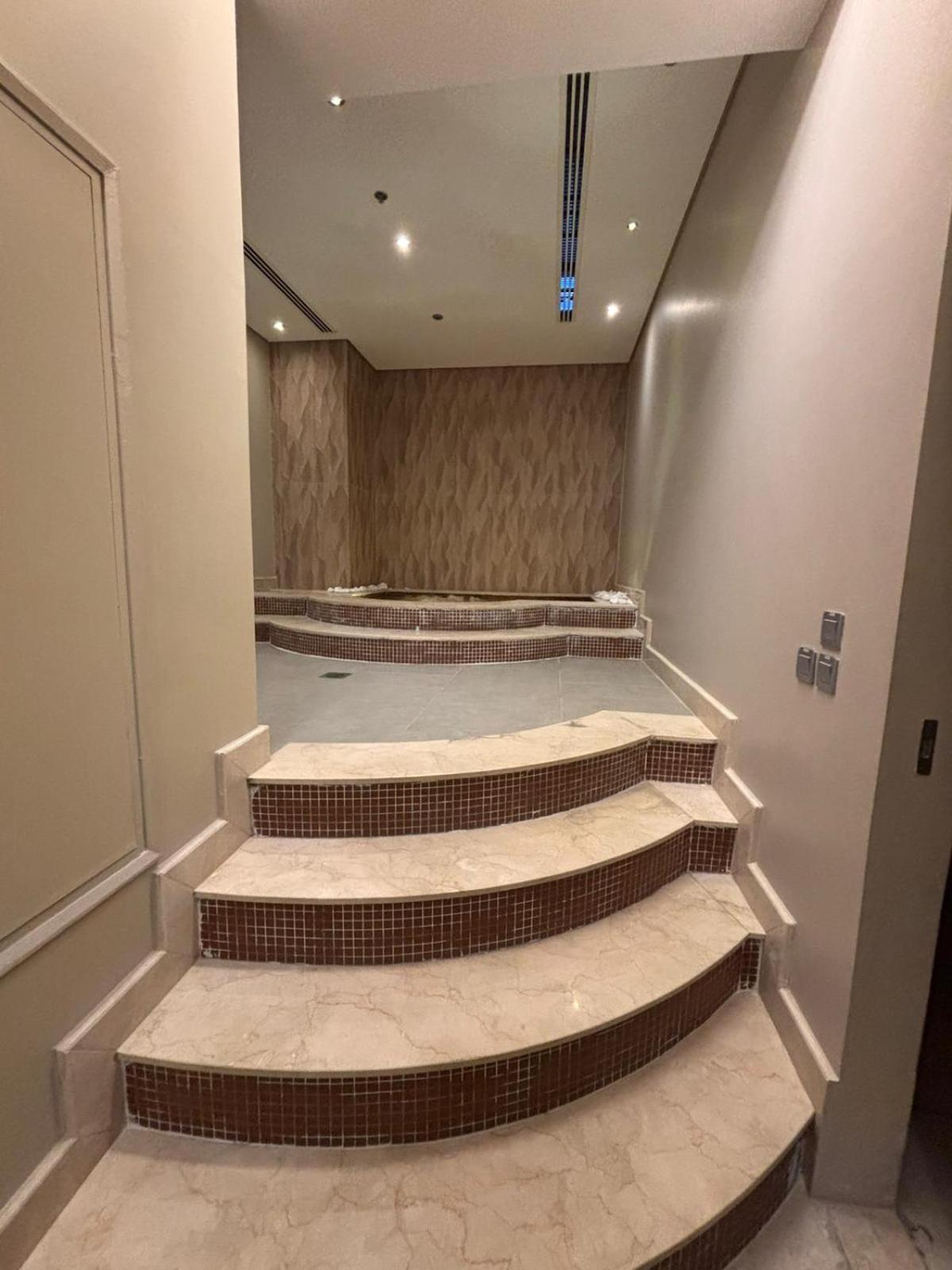 a set of stairs in a room with at Your dream place 1 BHK near City Centre Bahrain in Manama