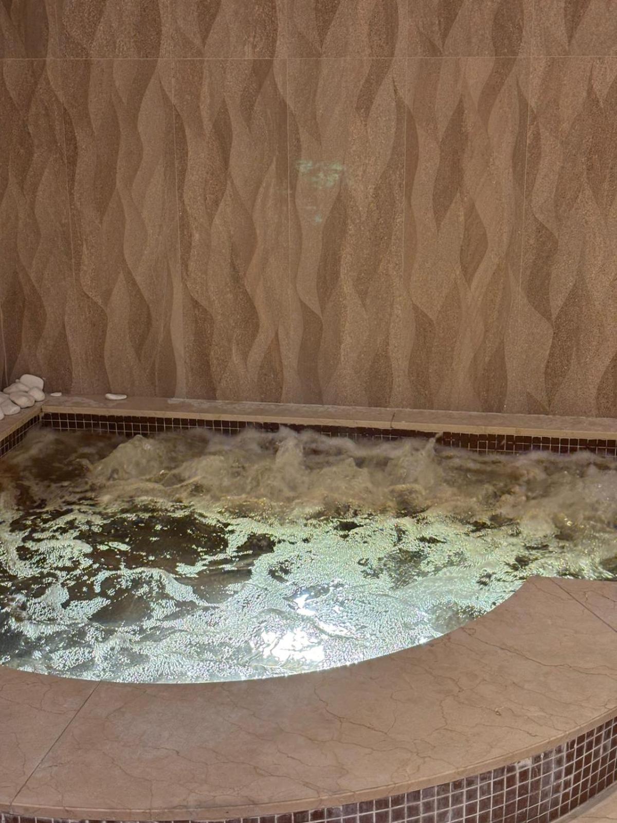 a large hot tub with water in a room at Your dream place 1 BHK near City Centre Bahrain in Manama +36 photos