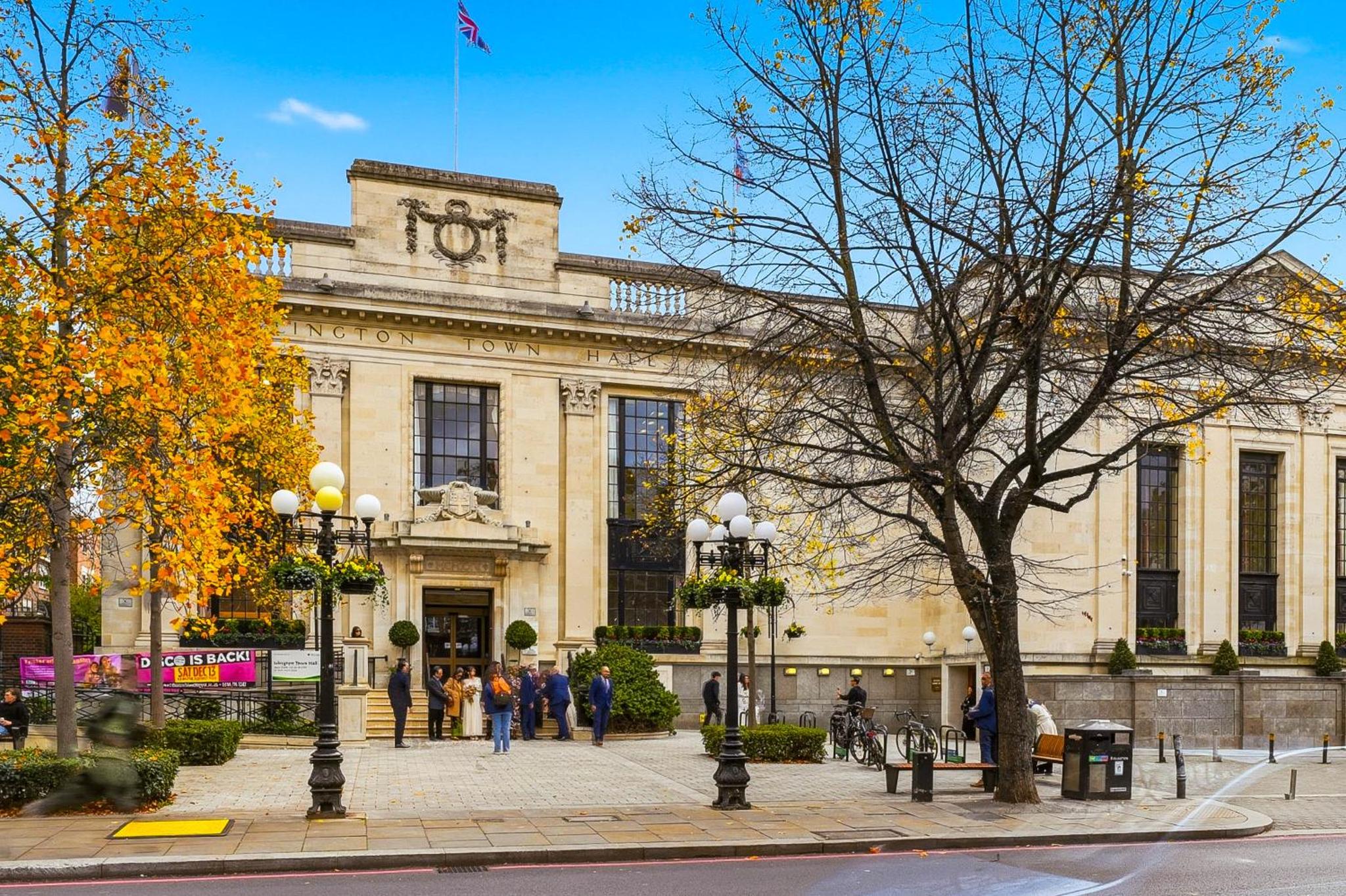 a large building with people walking in front of it at Bright & Stylish Flat in the Heart of Islington in London