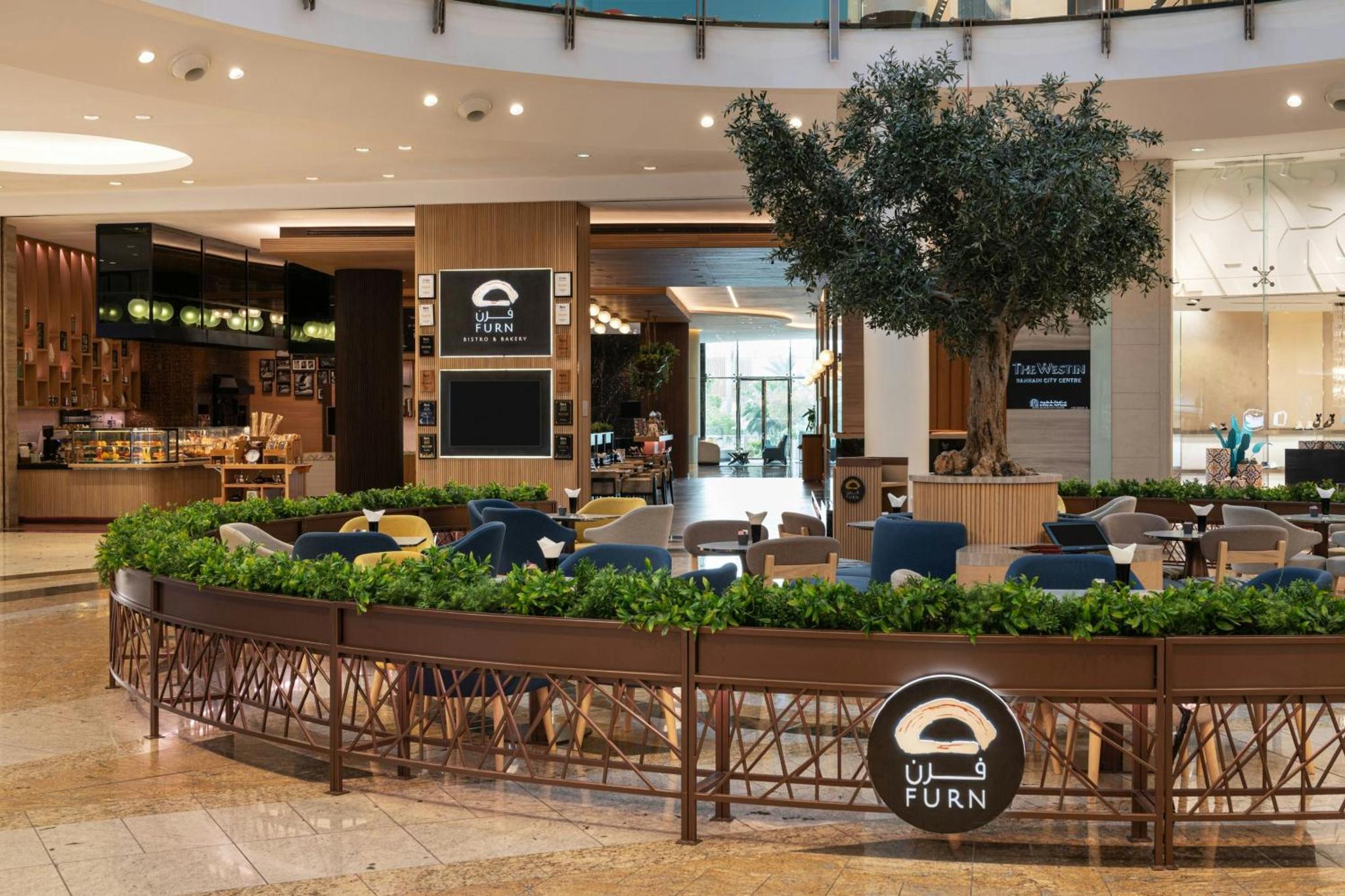 a restaurant with tables and chairs in a mall at The Westin City Centre Bahrain in Manama +94 photos