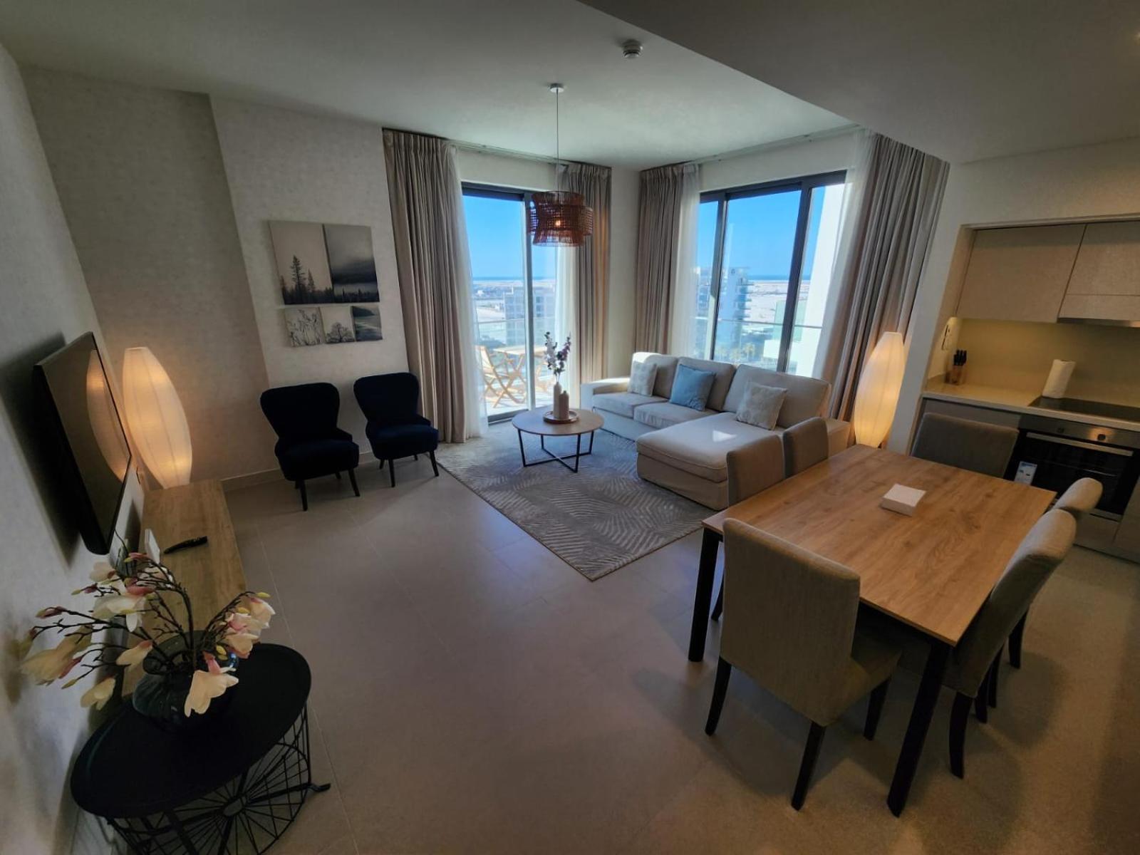 an overhead view of a living room with a table and chairs at Elite 2BR Abode Distinctive Living at The Shores in Manama