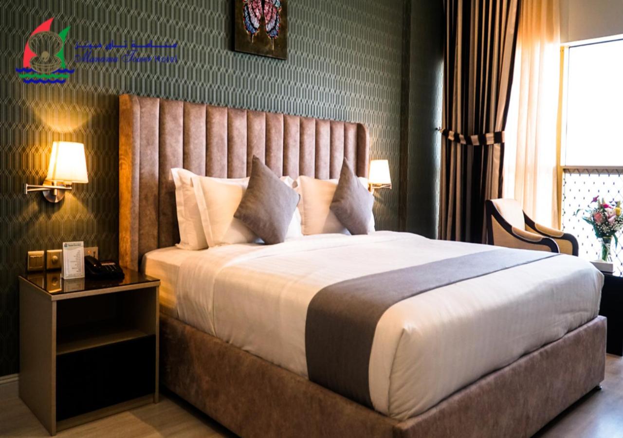 a bedroom with a large bed in a room at Manama Tower Hotel in Manama +17 photos