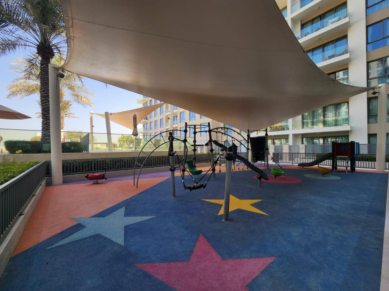 a playground with stars on a blue carpet at Elite 2BR Abode Distinctive Living at The Shores in Manama