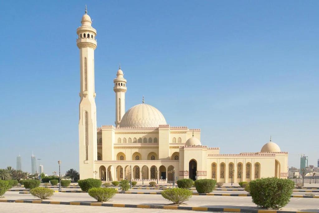 a mosque with a minaret and a dome at HAVEN TOWER in Juffair