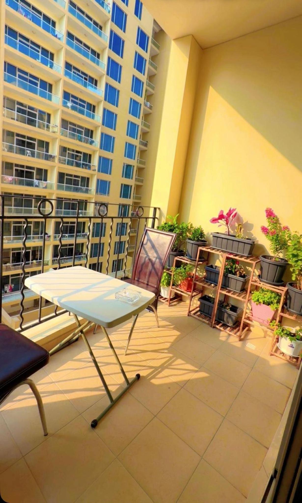 a table and chair on a balcony of a building at شقة خاصة in Muharraq