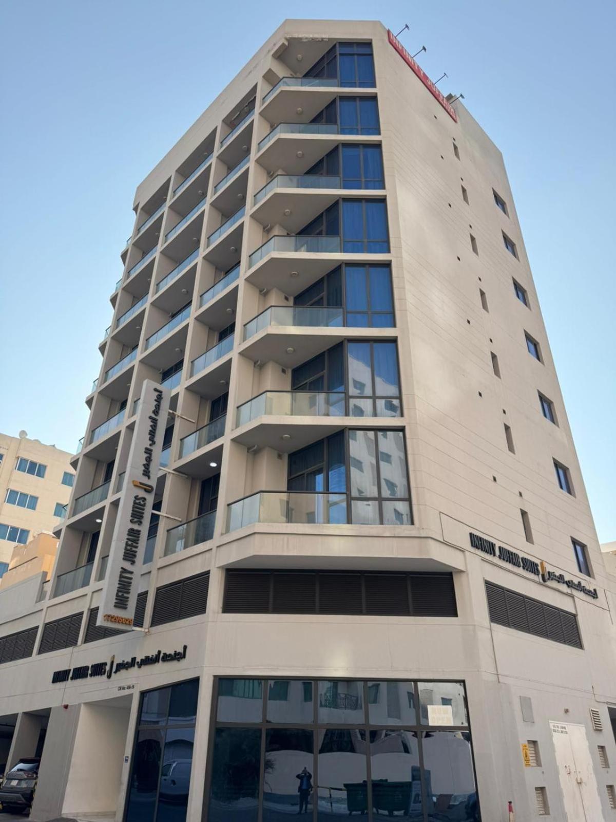 a tall apartment building with a lot of windows at INFINITY Suites Juffair in Manama