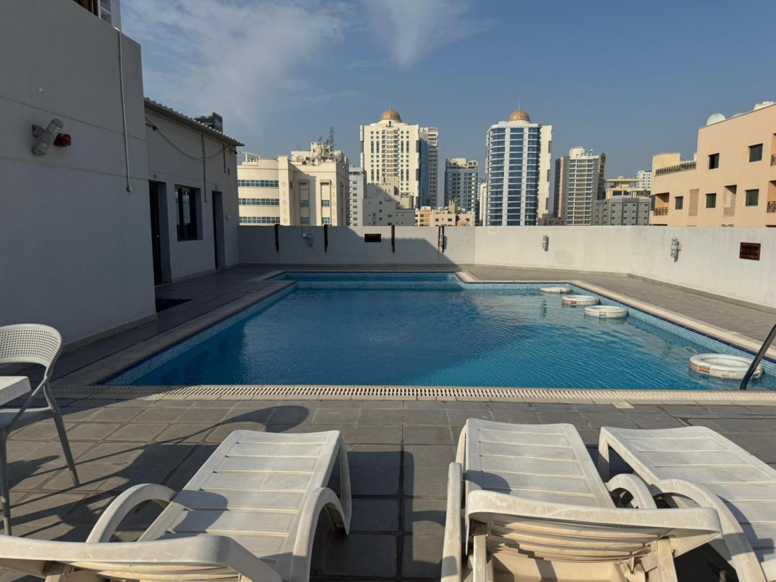 a swimming pool on the roof of a building at INFINITY Suites Juffair in Manama