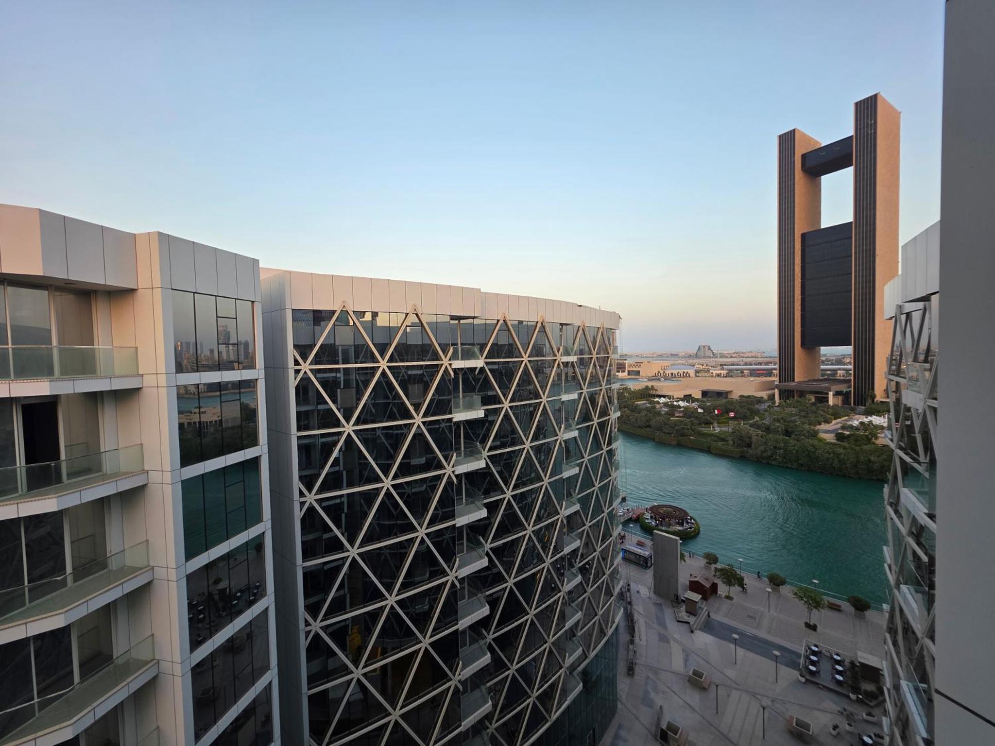 an aerial view of two buildings and a river at Elite 1BR - Sea View & Four Seasons Scene in Manama