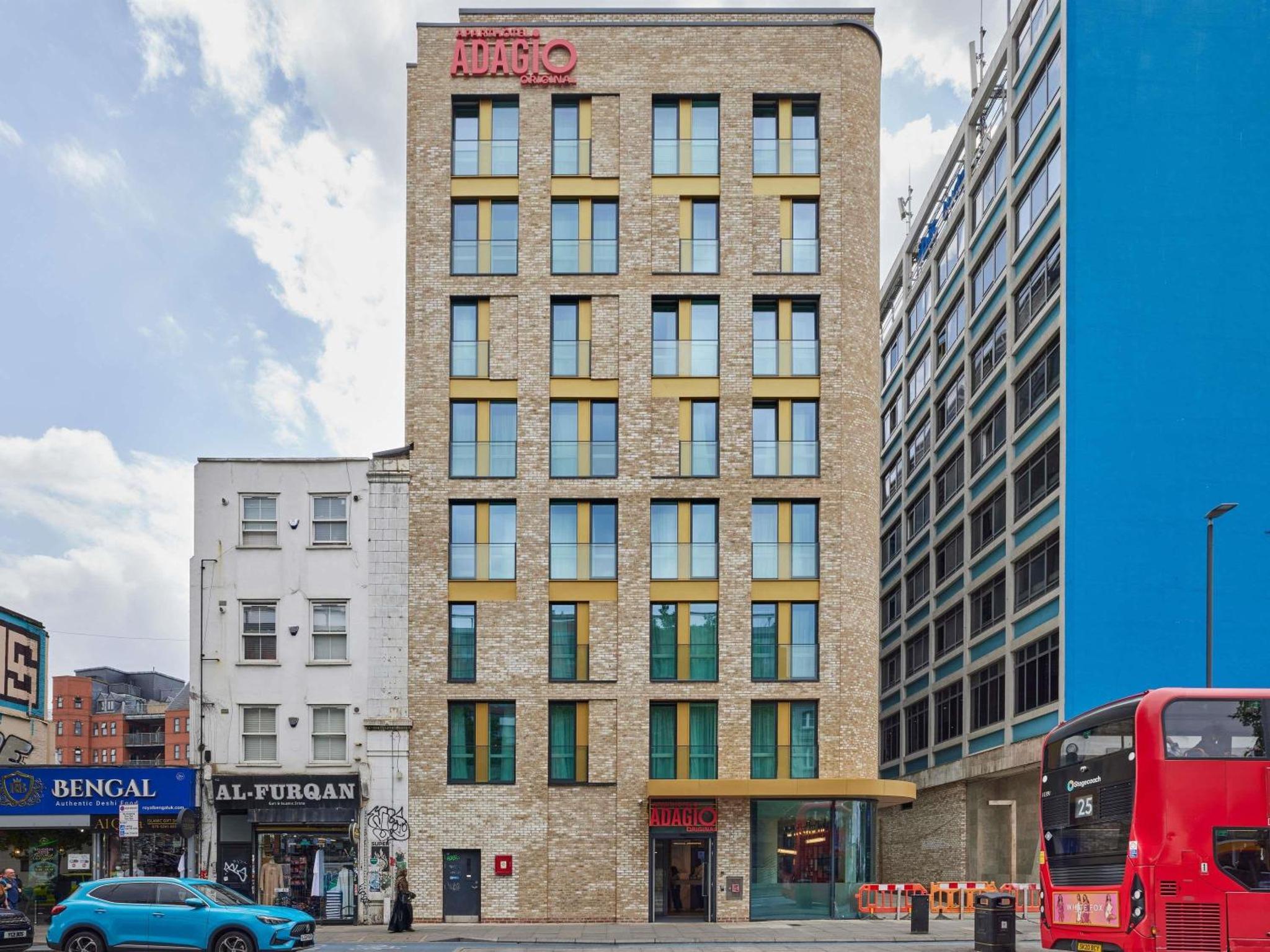 a tall brick building with a sign on it at Aparthotel Adagio London City East in London