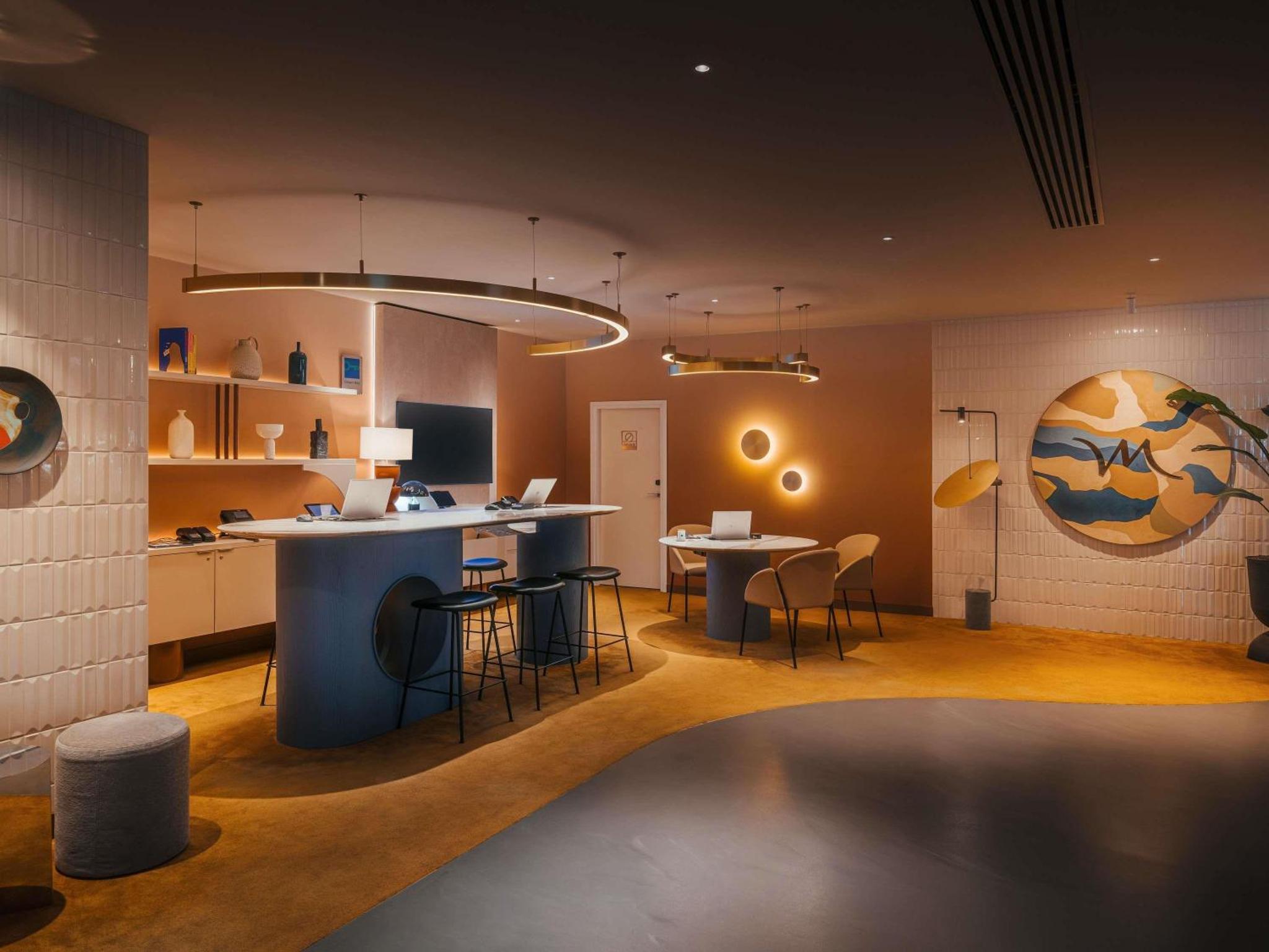 a kitchen with a blue island in a room at Mercure London Earls Court in London