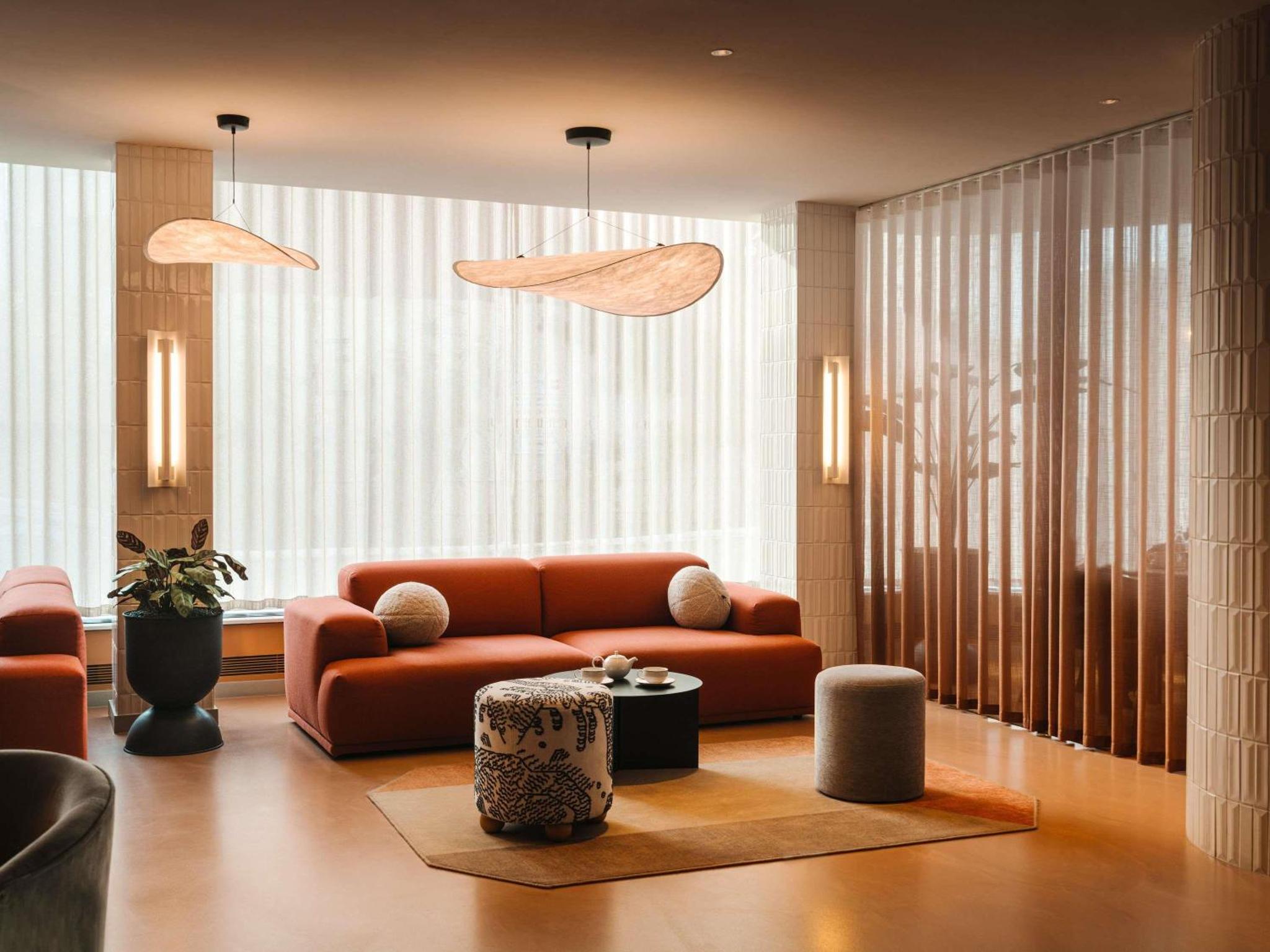 a living room with a couch and a table at Mercure London Earls Court in London