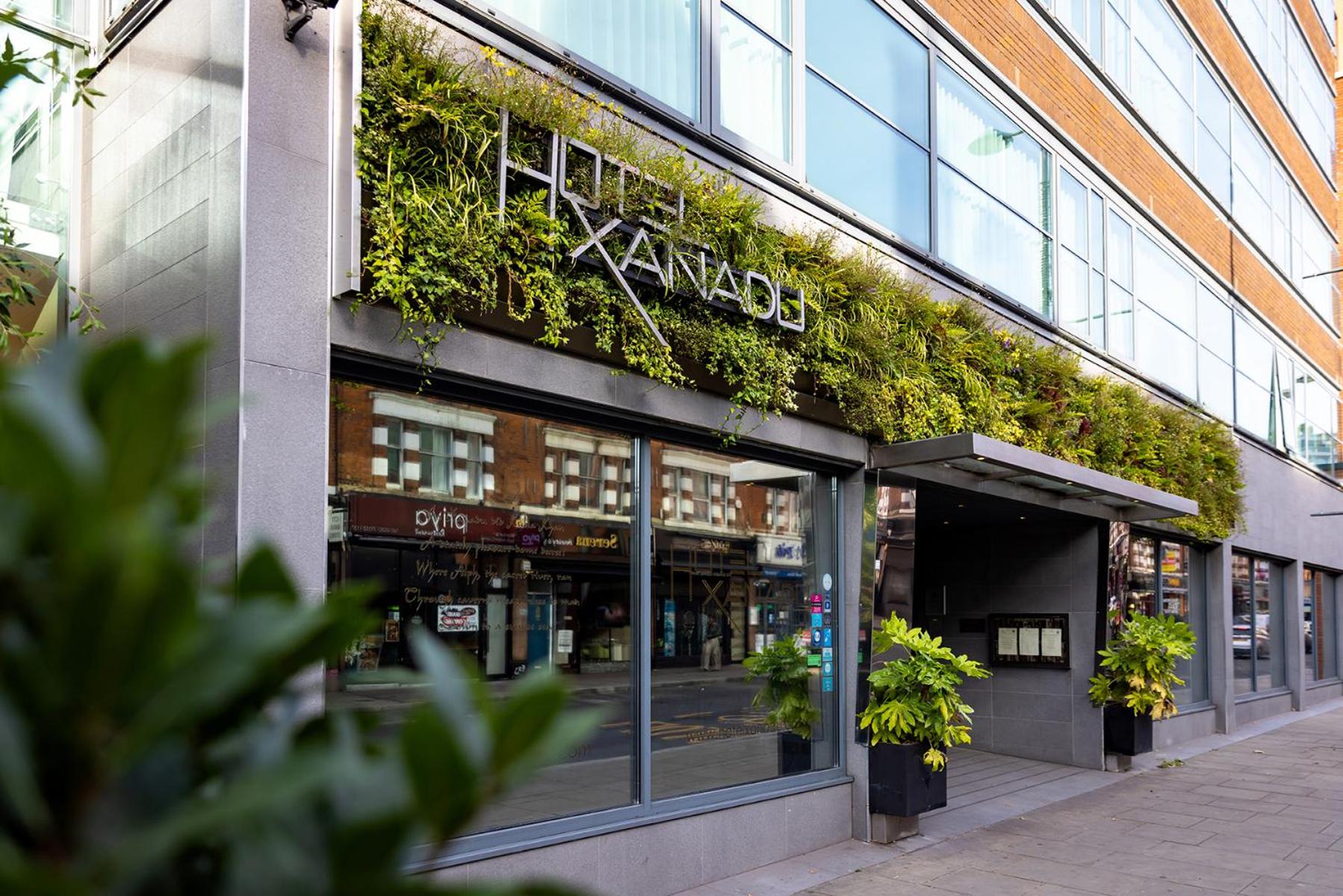 a store front of a building with plants on it at Hotel Xanadu in London